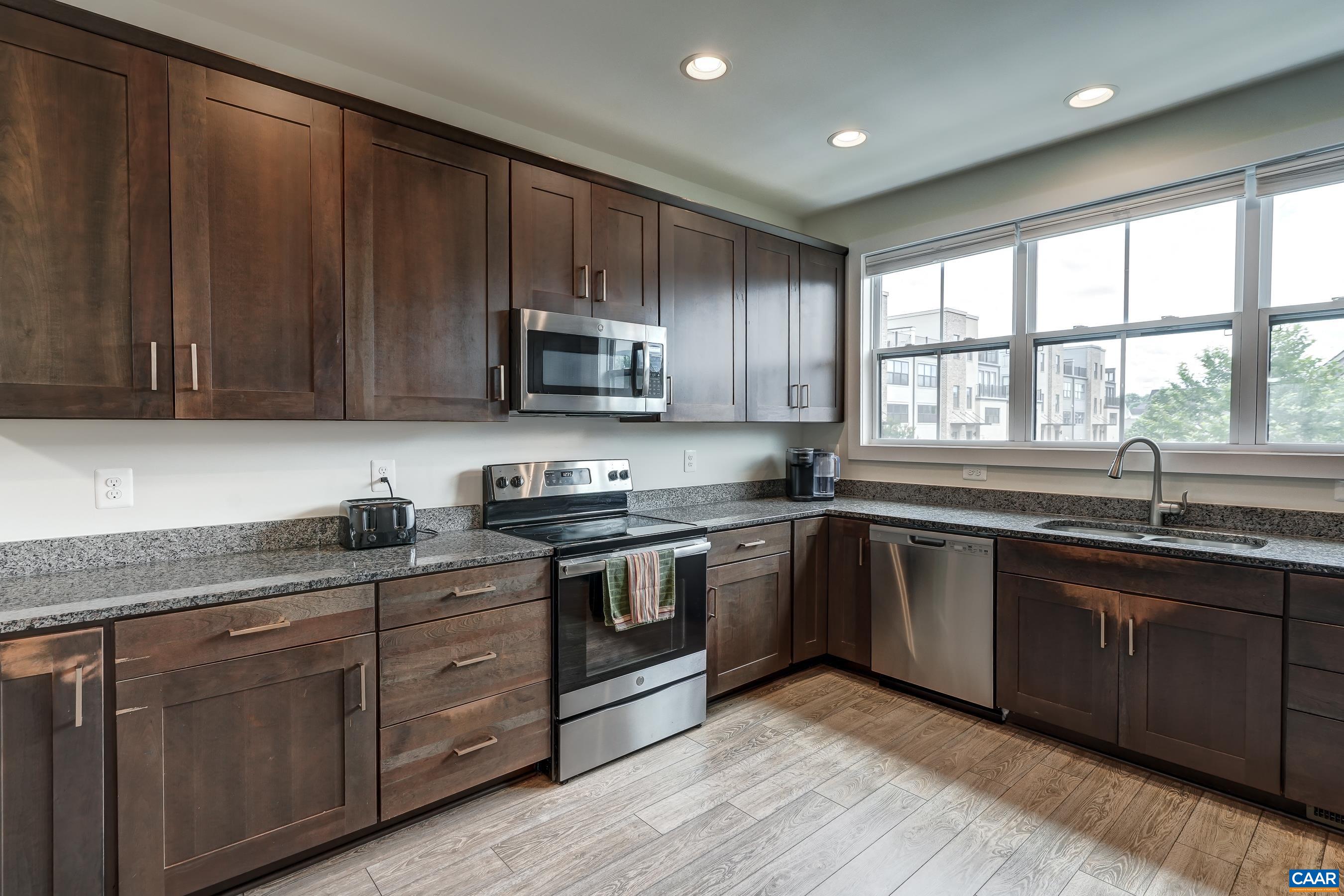 Hardwood cabinets and stainless steel appliances.