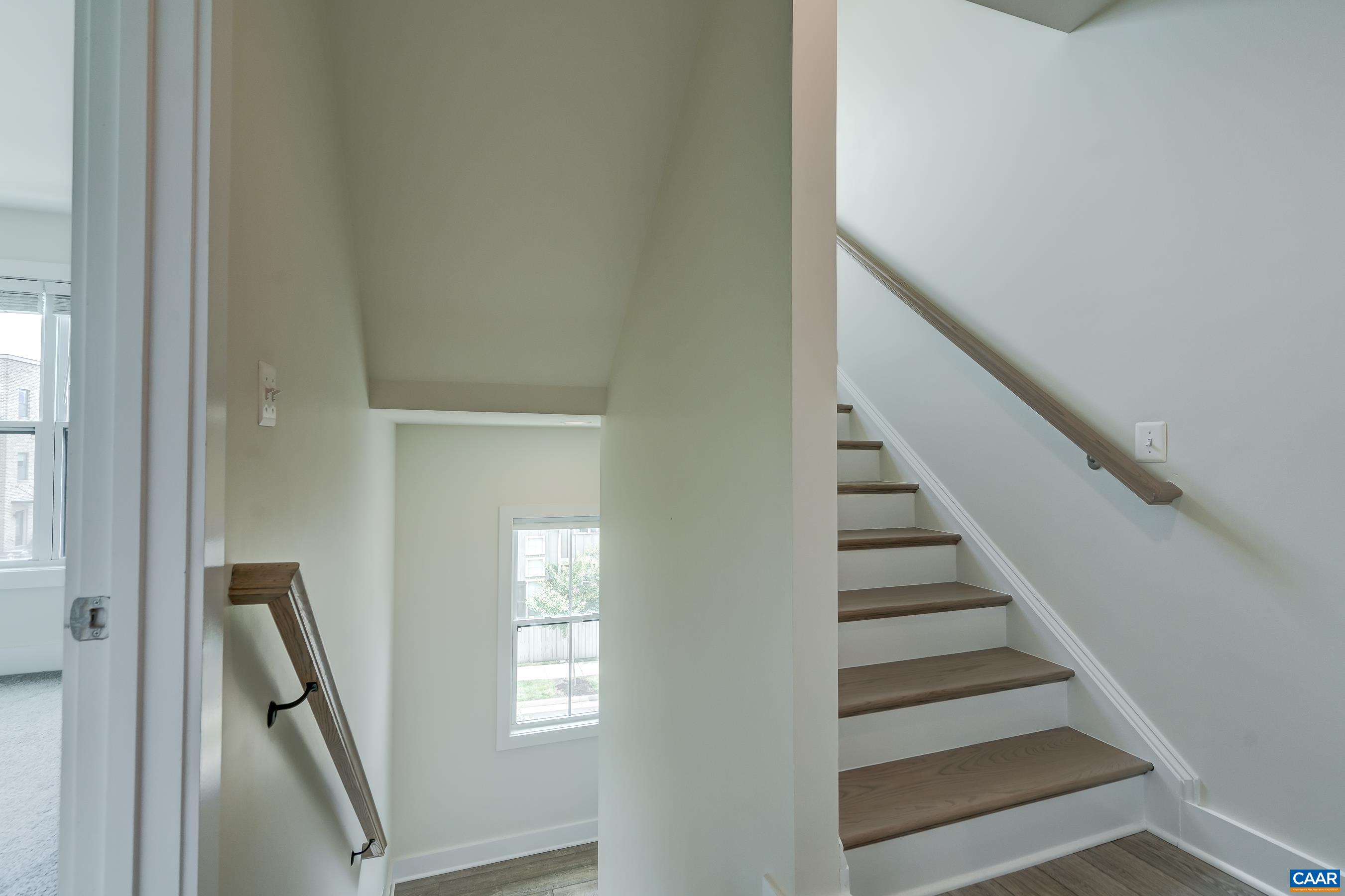 Stairs lead up to home office/loft.