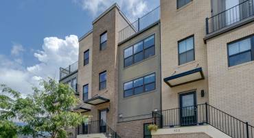 Quad level townhome with two primary suites and a rooftop deck in Old Trail!