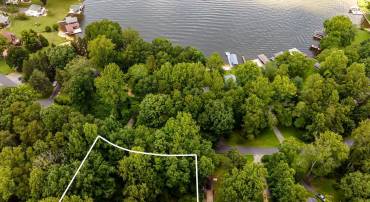 4B/2BA home and detached large garage plus shed on three combined lots. Beach and playground are a short walk to the left, BRS #5 Boat dock is just to the right of property.
