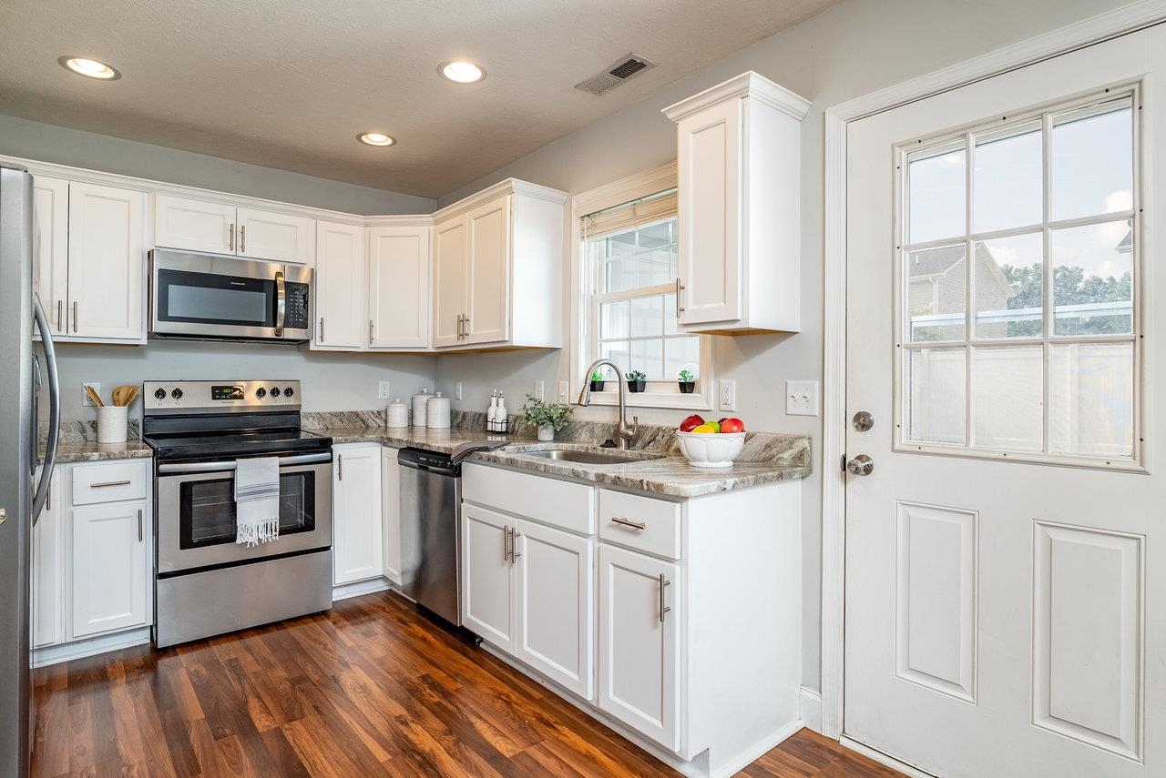 Granite countertops, stainless steel appliances and white cabinets for a modern look.