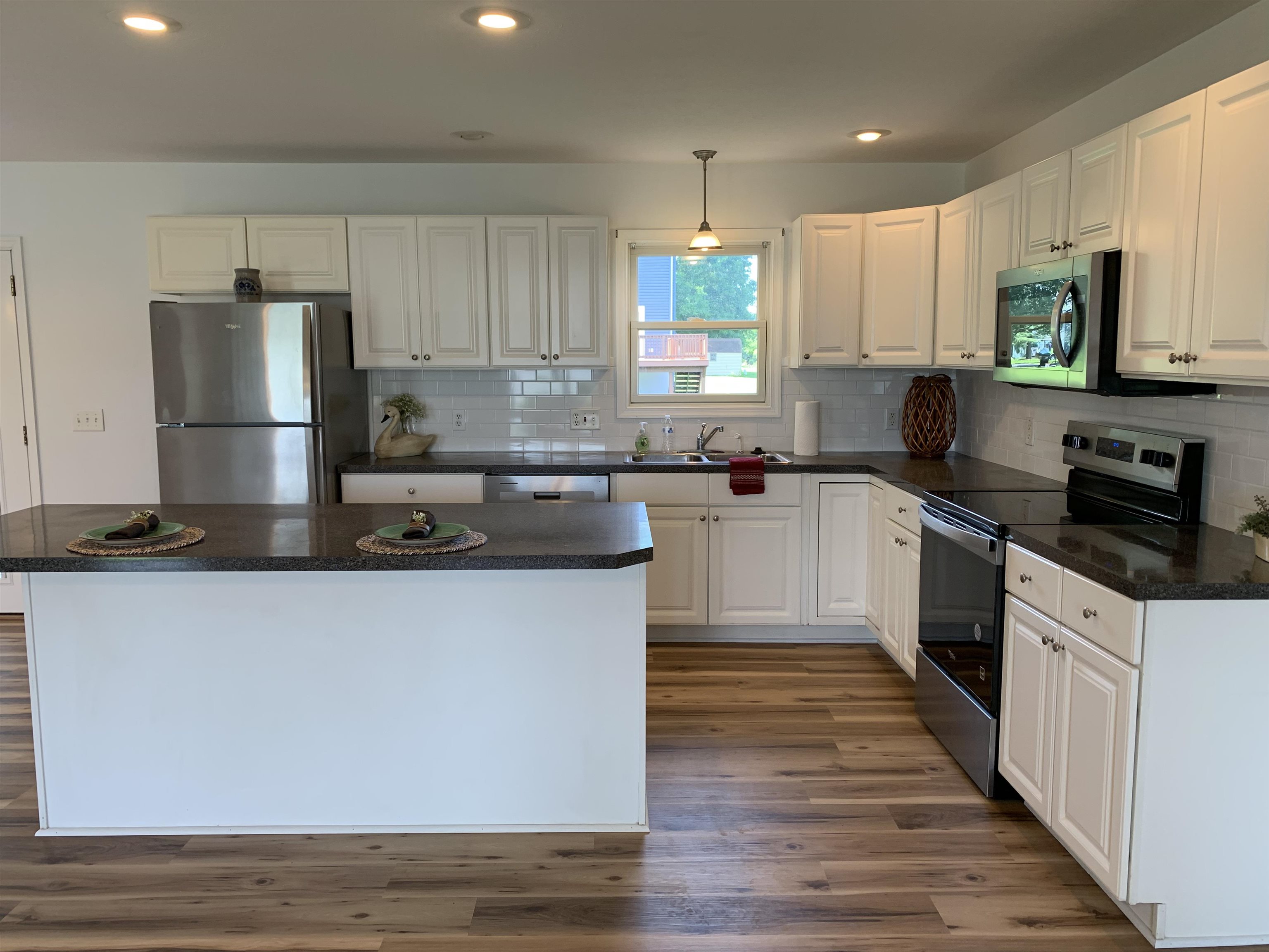 New Whirlpool appliances include refrigerator, stove, microwave and dishwasher