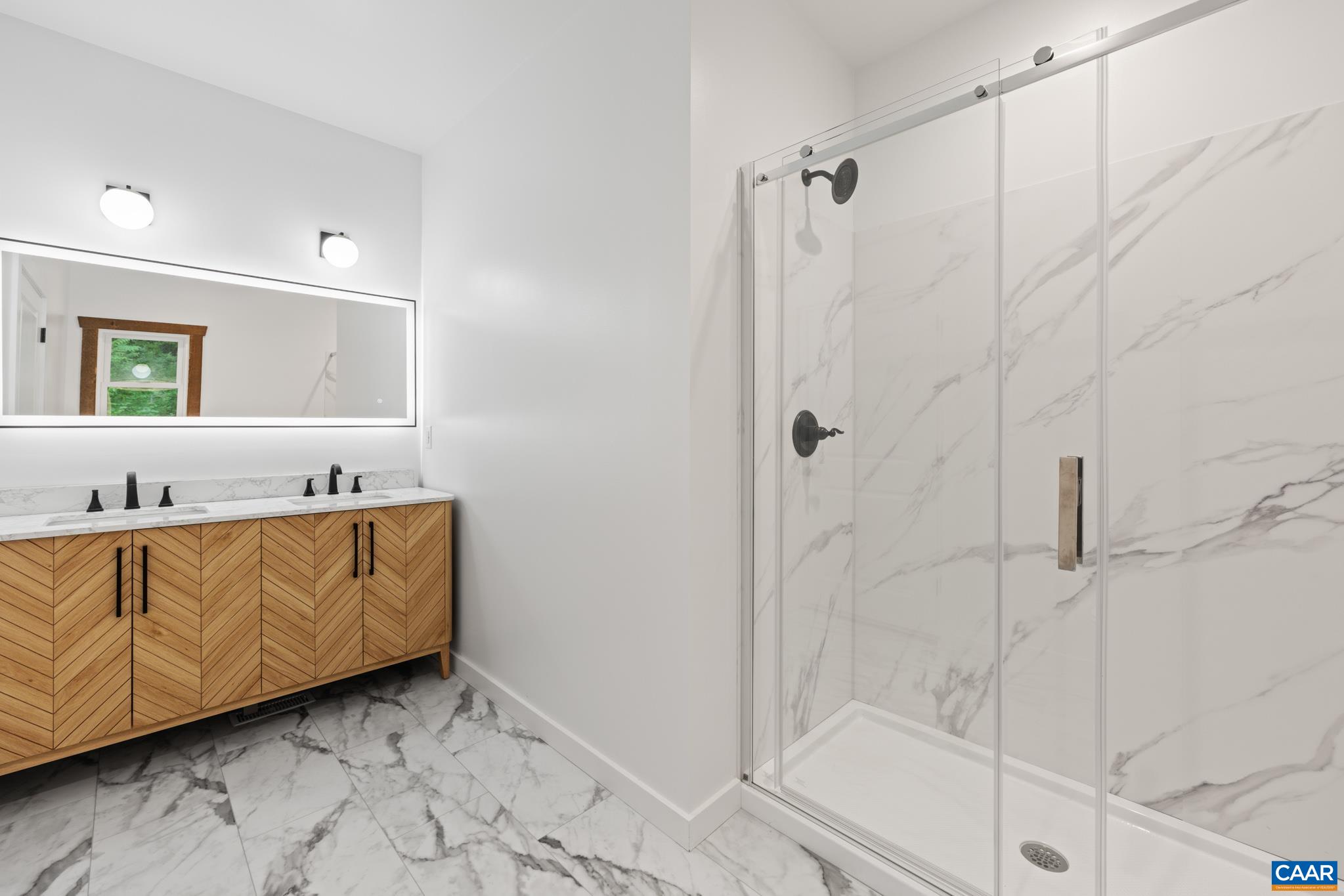Richly tiled in neutral tones, the primary bathroom offers a walk in shower with subtle textures and natural finishes - blending comfort and style in a calming retreat. This shower combines elegance with everyday functionality.
