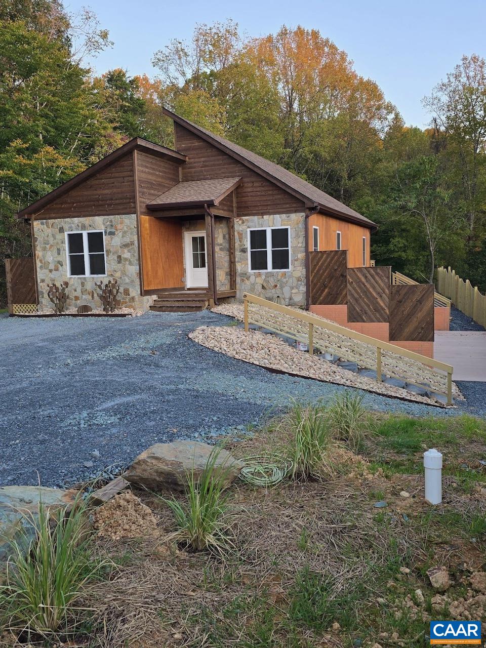 Exterior siding crafted from Okoume African hardwood and Montana Ghostwood; custom slate stairs from Buckingham Slate.