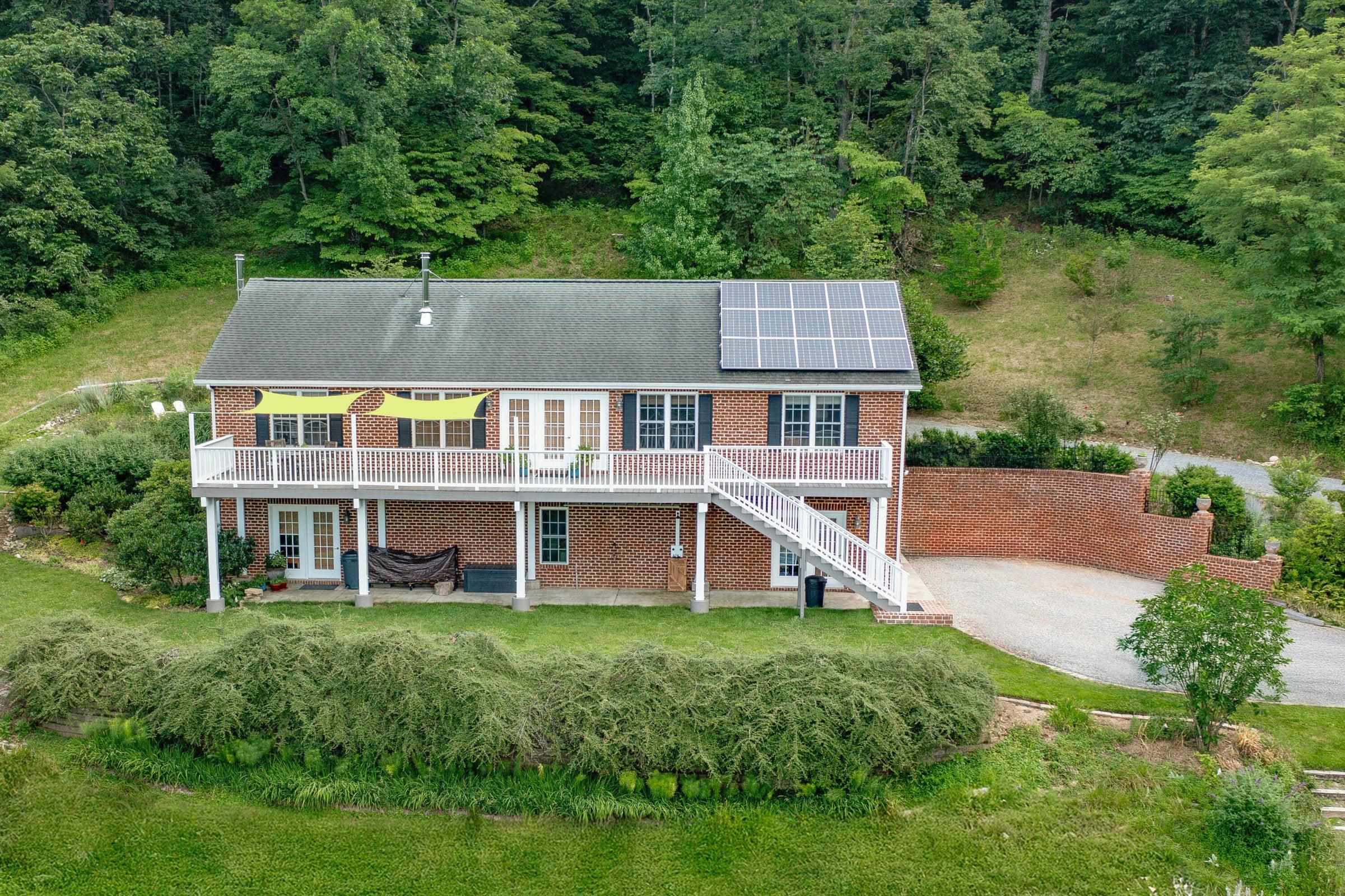 Views from the deck are spectacular. Open floor plan opens out to the deck. Notice solar panel on the roof. Walk-out finished basement.