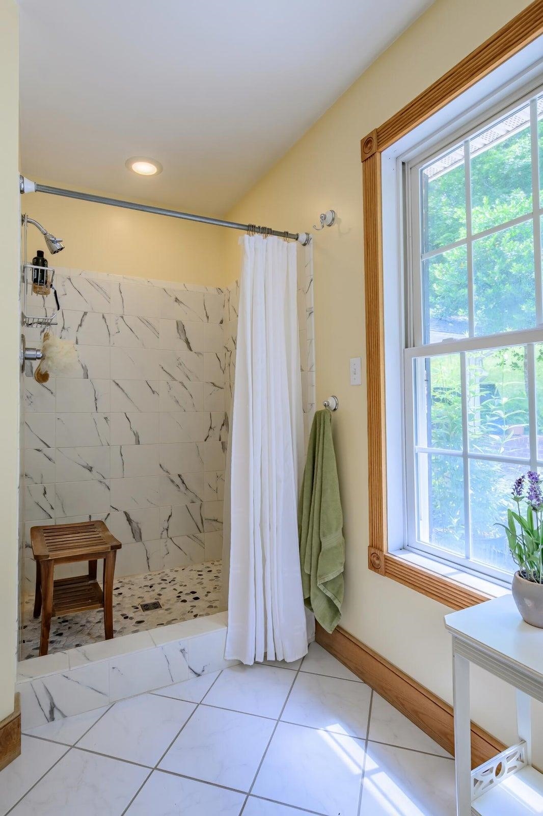 Newly tiled shower installed by the current owners.