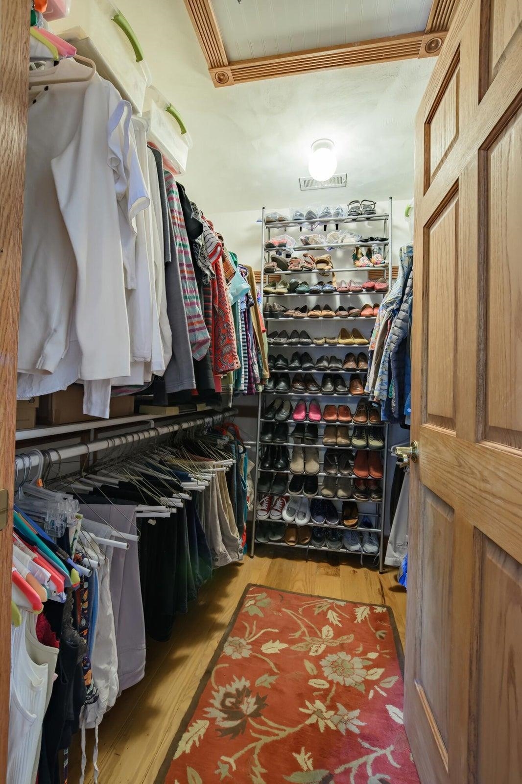 Walk-in closet with access to the attic in the ceiling.