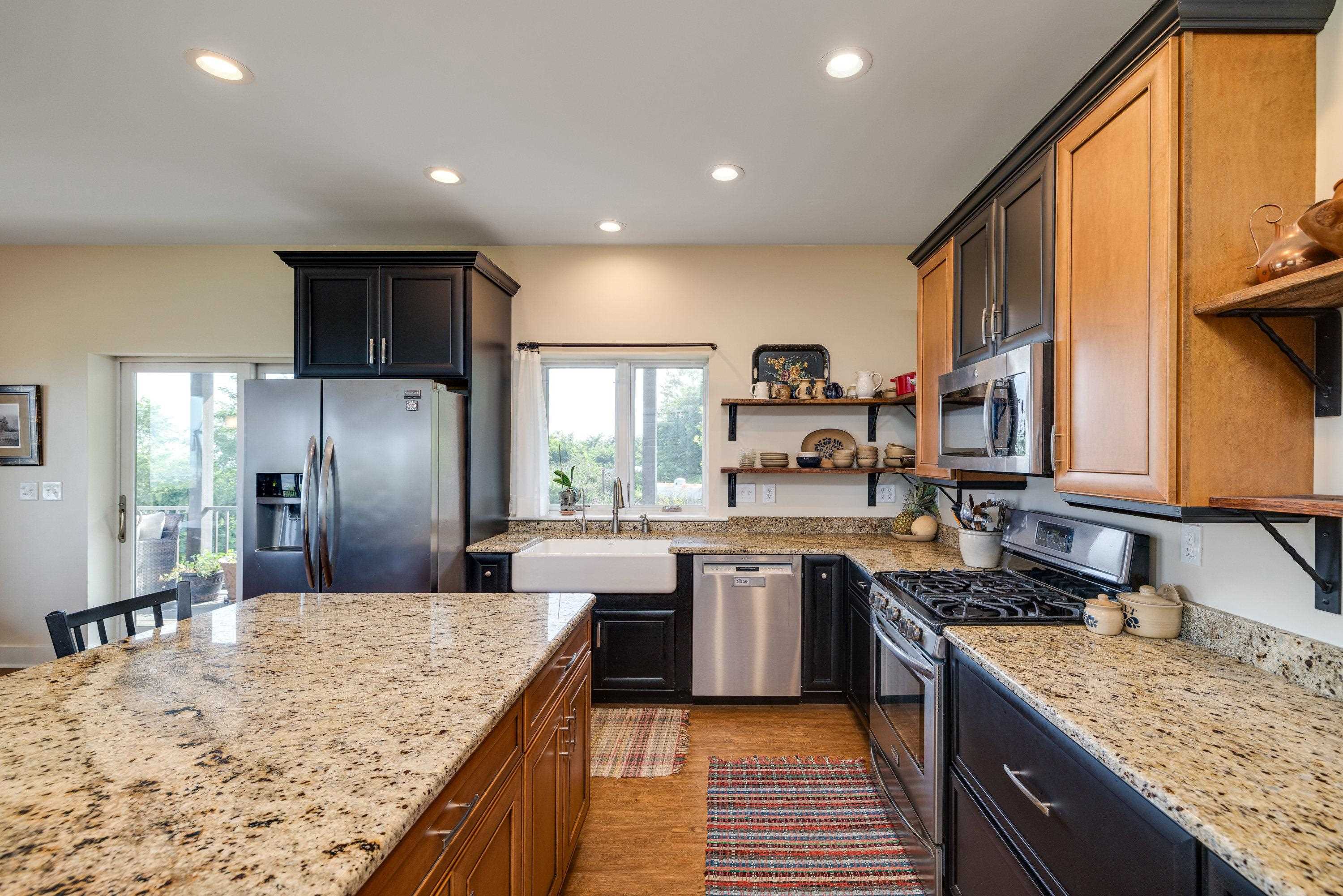 The kitchen features hardwood flooring throughout the space.  Wooden cabinetry, granite counter-tops, recessed lighting, eat-up island area, stainless steel appliances, and much more!