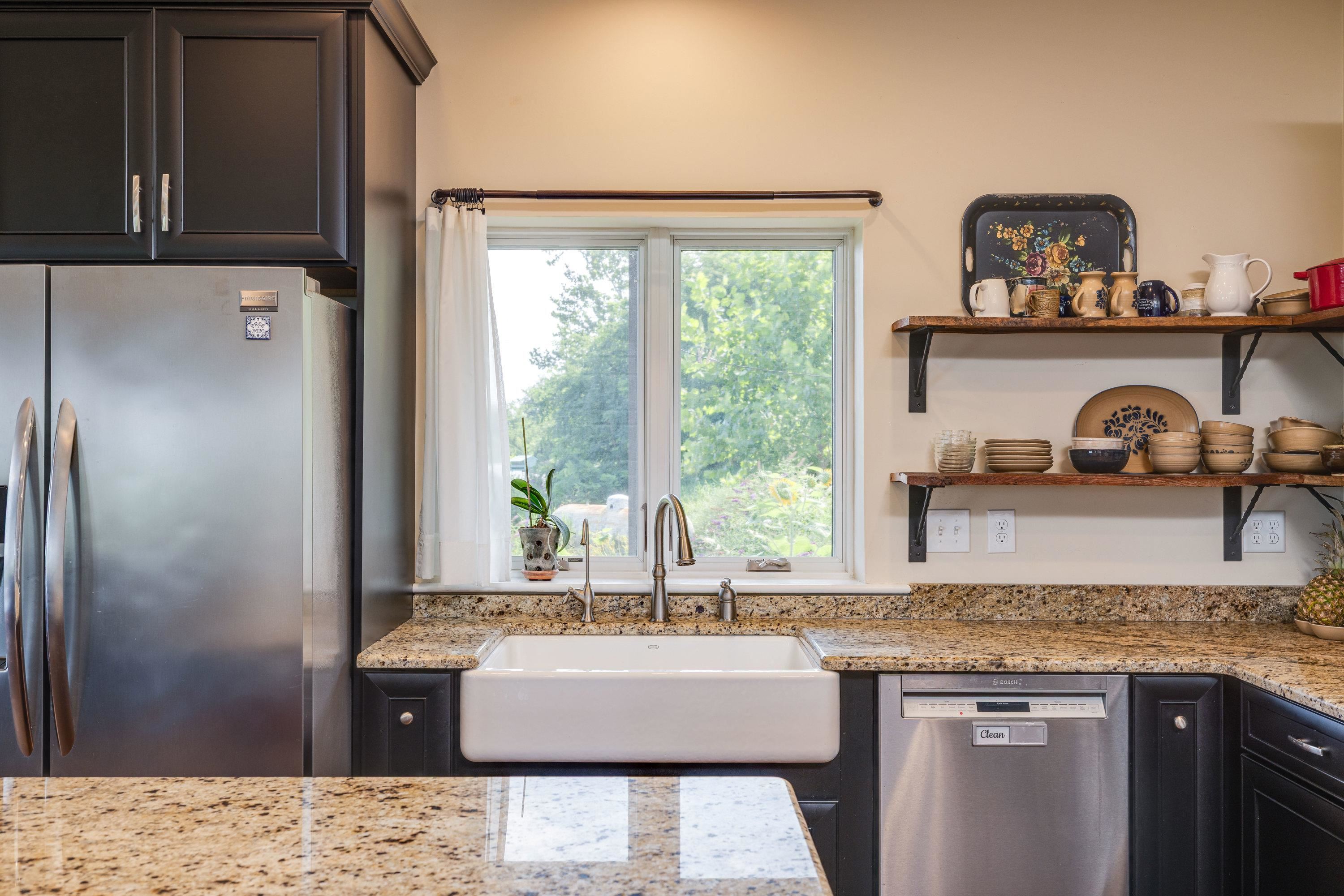 The kitchen features hardwood flooring throughout the space.  Wooden cabinetry, granite counter-tops, recessed lighting, eat-up island area, stainless steel appliances, and much more!