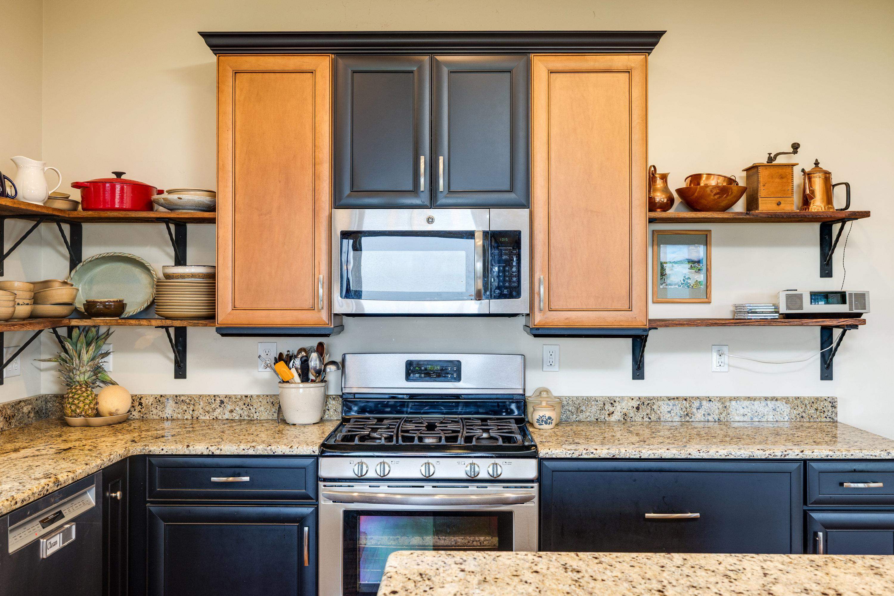 The kitchen features hardwood flooring throughout the space.  Wooden cabinetry, granite counter-tops, recessed lighting, eat-up island area, stainless steel appliances, and much more!