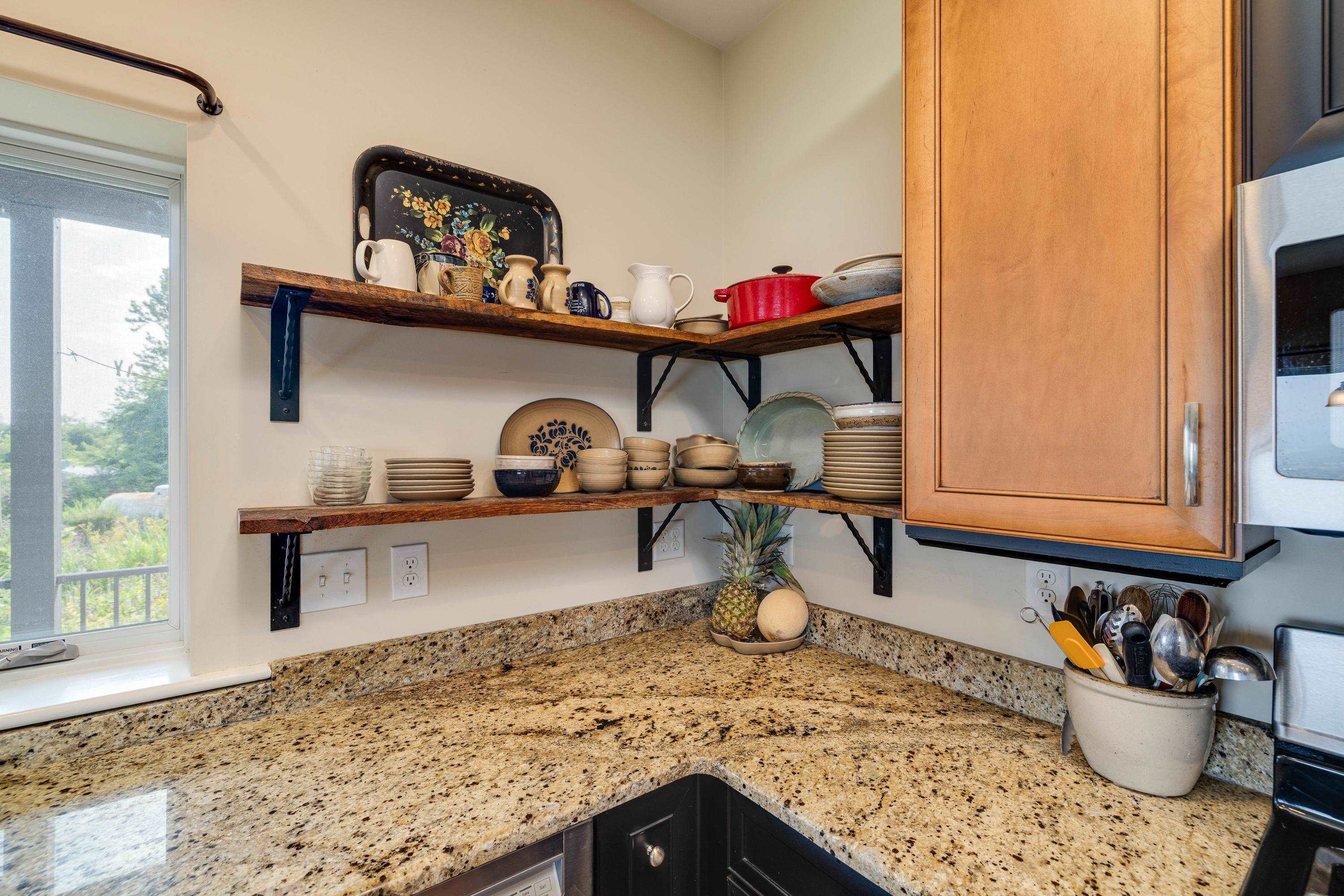 The kitchen features hardwood flooring throughout the space.  Wooden cabinetry, granite counter-tops, recessed lighting, eat-up island area, stainless steel appliances, and much more!