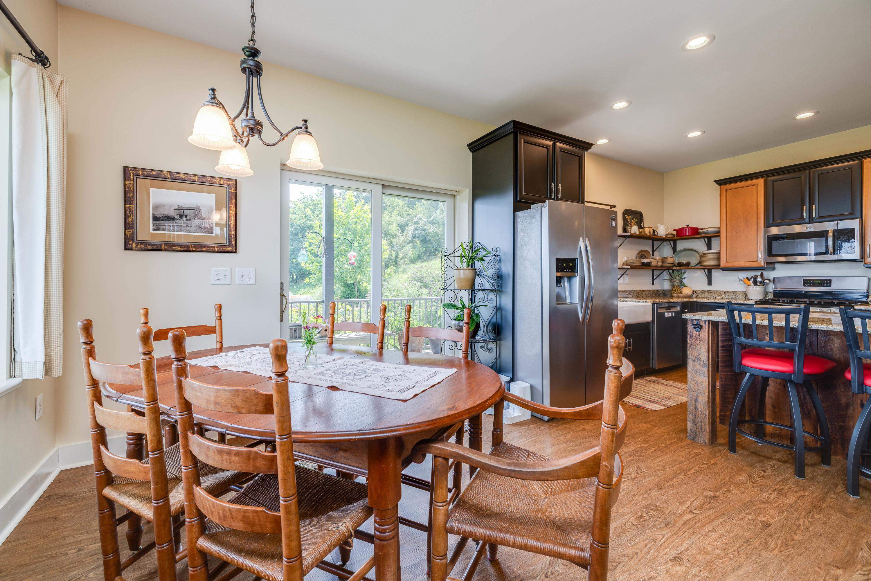 Directly off the kitchen is a large dining area.  This space features a chandelier, hardwood flooring, windows overlooking a view of the mountains, and plenty of space for a table and chairs set.