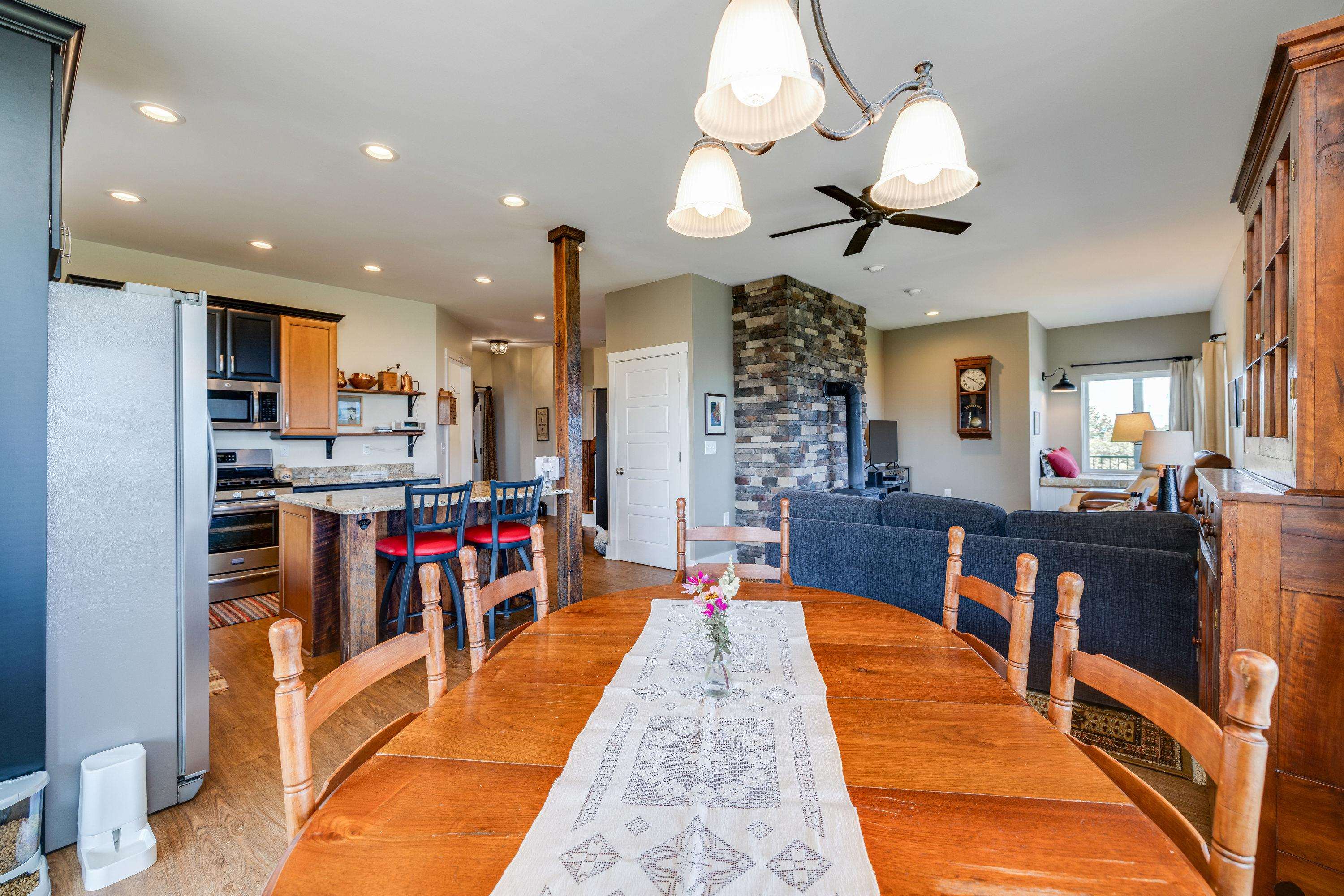 Directly off the kitchen is a large dining area.  This space features a chandelier, hardwood flooring, windows overlooking a view of the mountains, and plenty of space for a table and chairs set.