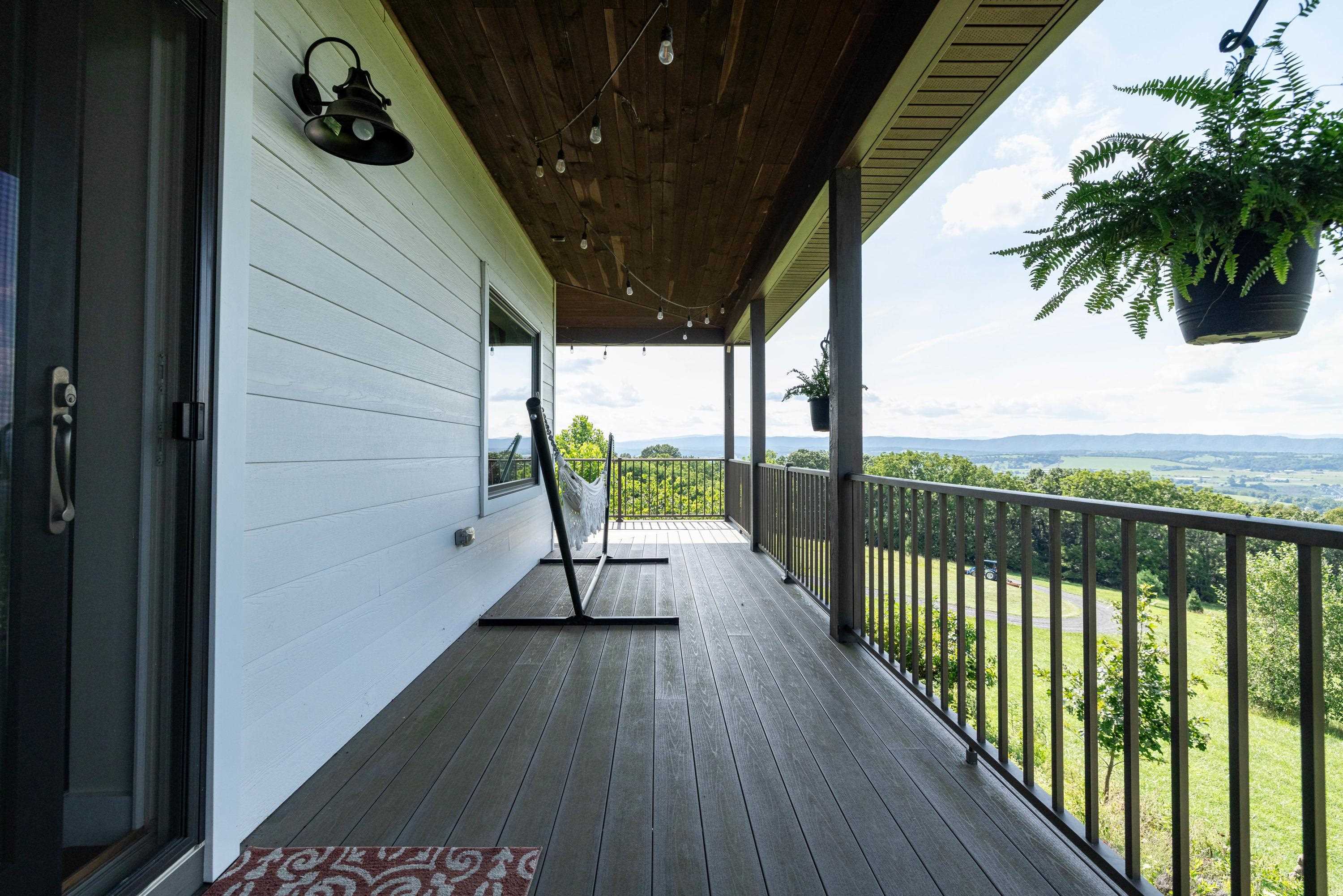 The spacious front porch allows a covered area for overlooking the beautiful views the home offers.  This porch features composite building materials, and is large enough for a table and chairs set.