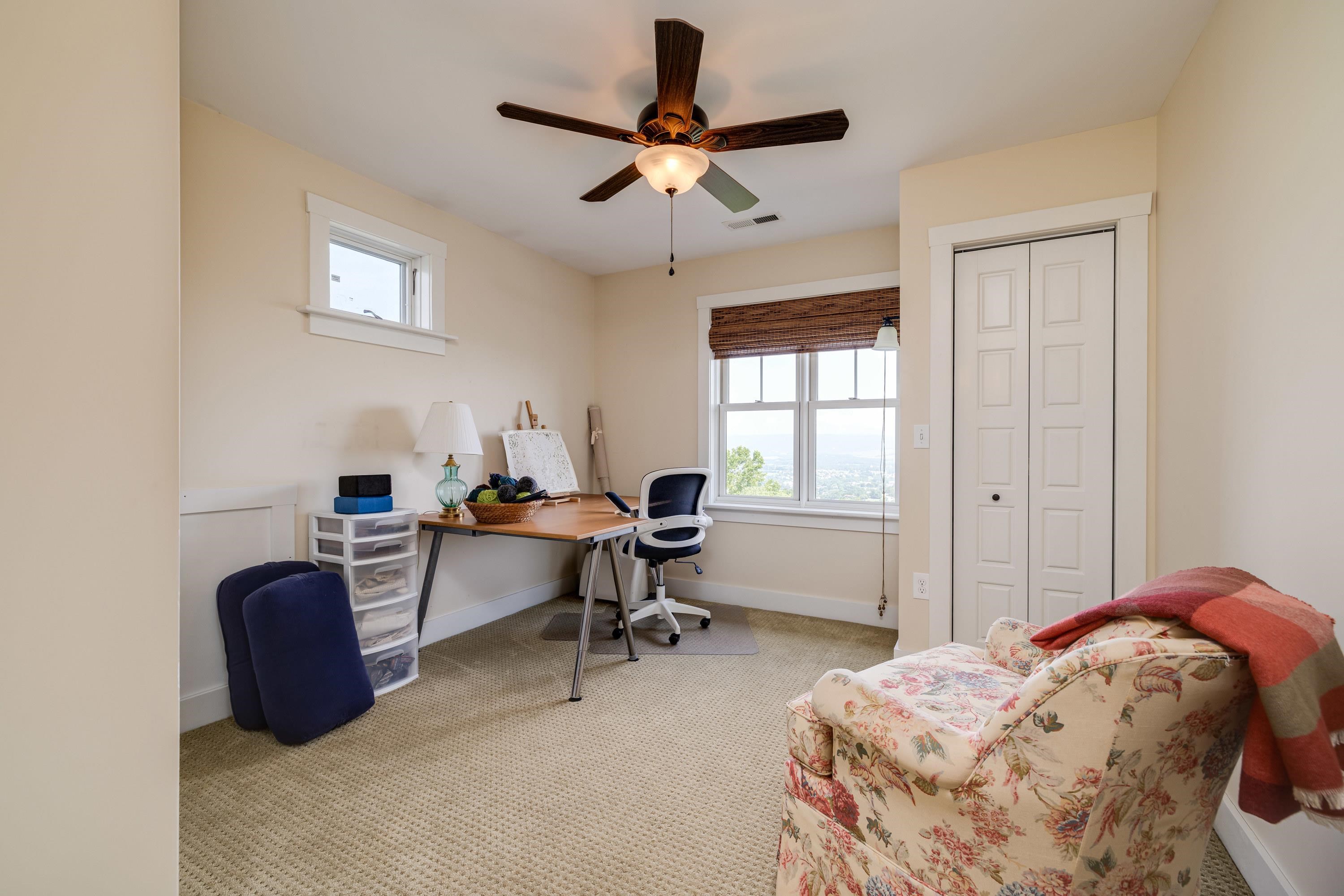 This second bedroom is on the upper level of the home.   This bedroom featurs a large closet, ceiling fan, comfortable flooring throughout, beautiful views, and more!