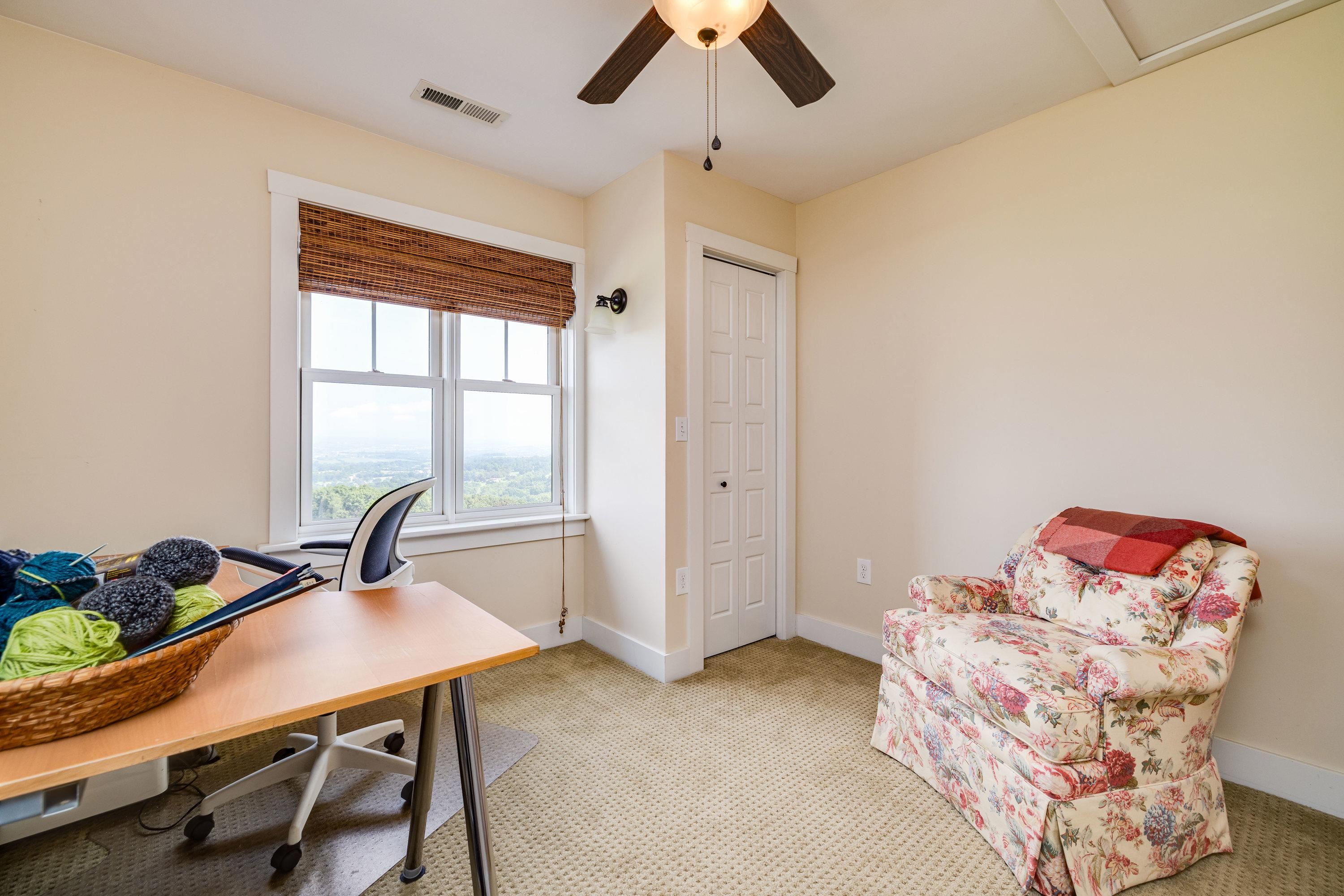 This second bedroom is on the upper level of the home.   This bedroom featurs a large closet, ceiling fan, comfortable flooring throughout, beautiful views, and more!