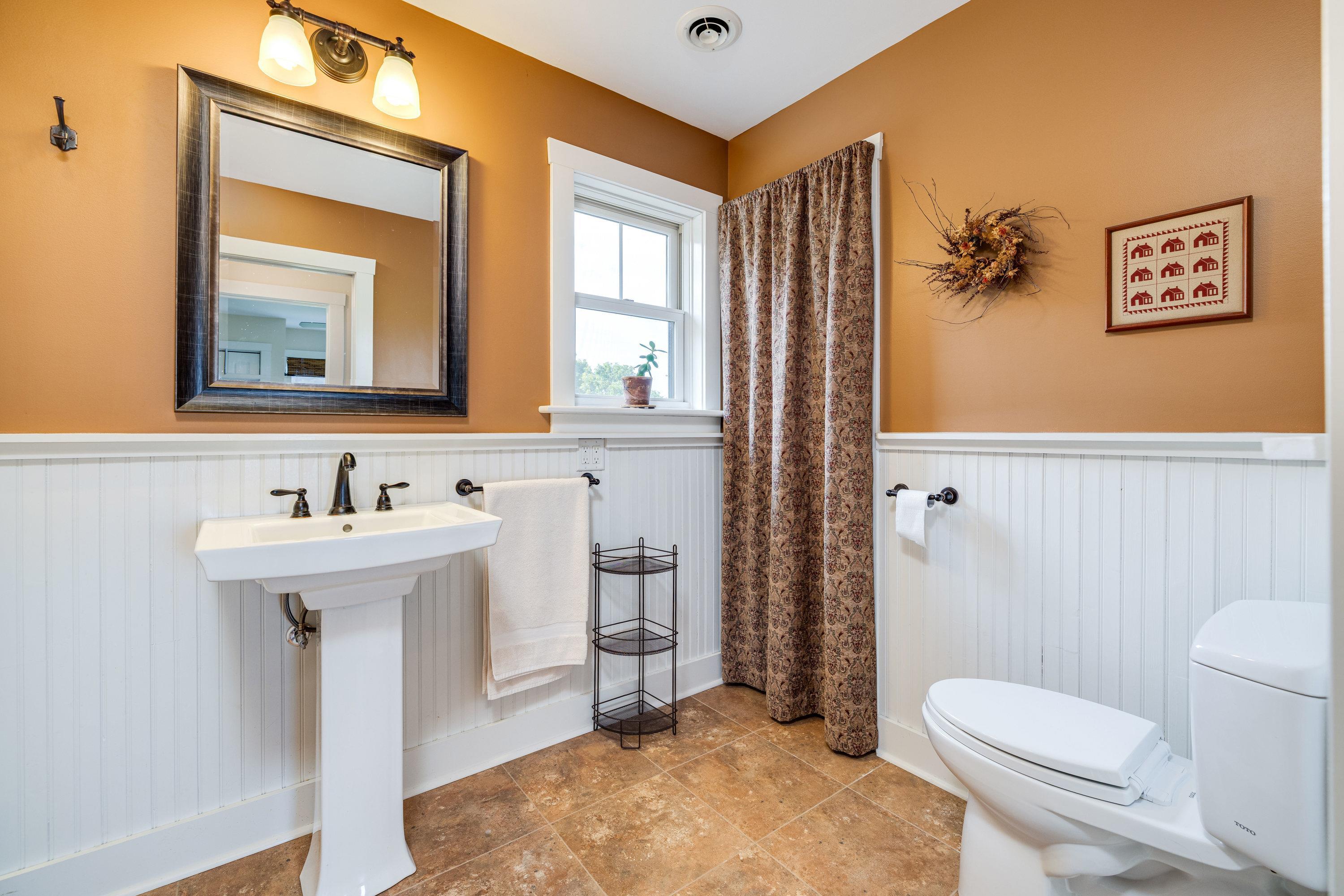 This full bathroom offers convenience to bedroom 2 and 3.  This bathroom features a pedastal sink and features a full bathtub/shower combination.