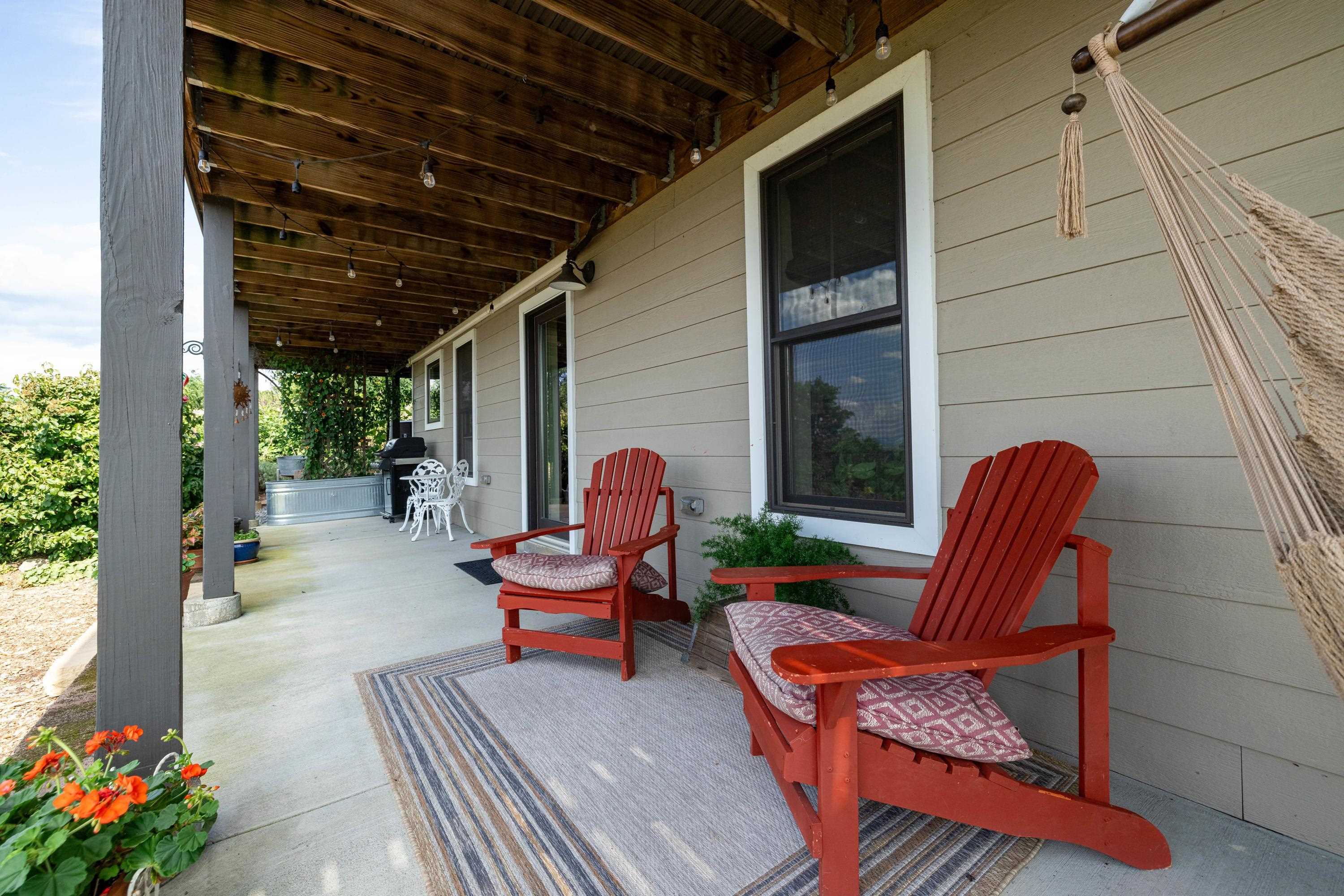 The lower level of the home features a full covered patio space.  This patio overlooks the amazing views of the home and enters into the short term rental unit featuring 1 bedroom and 1 bathroom.