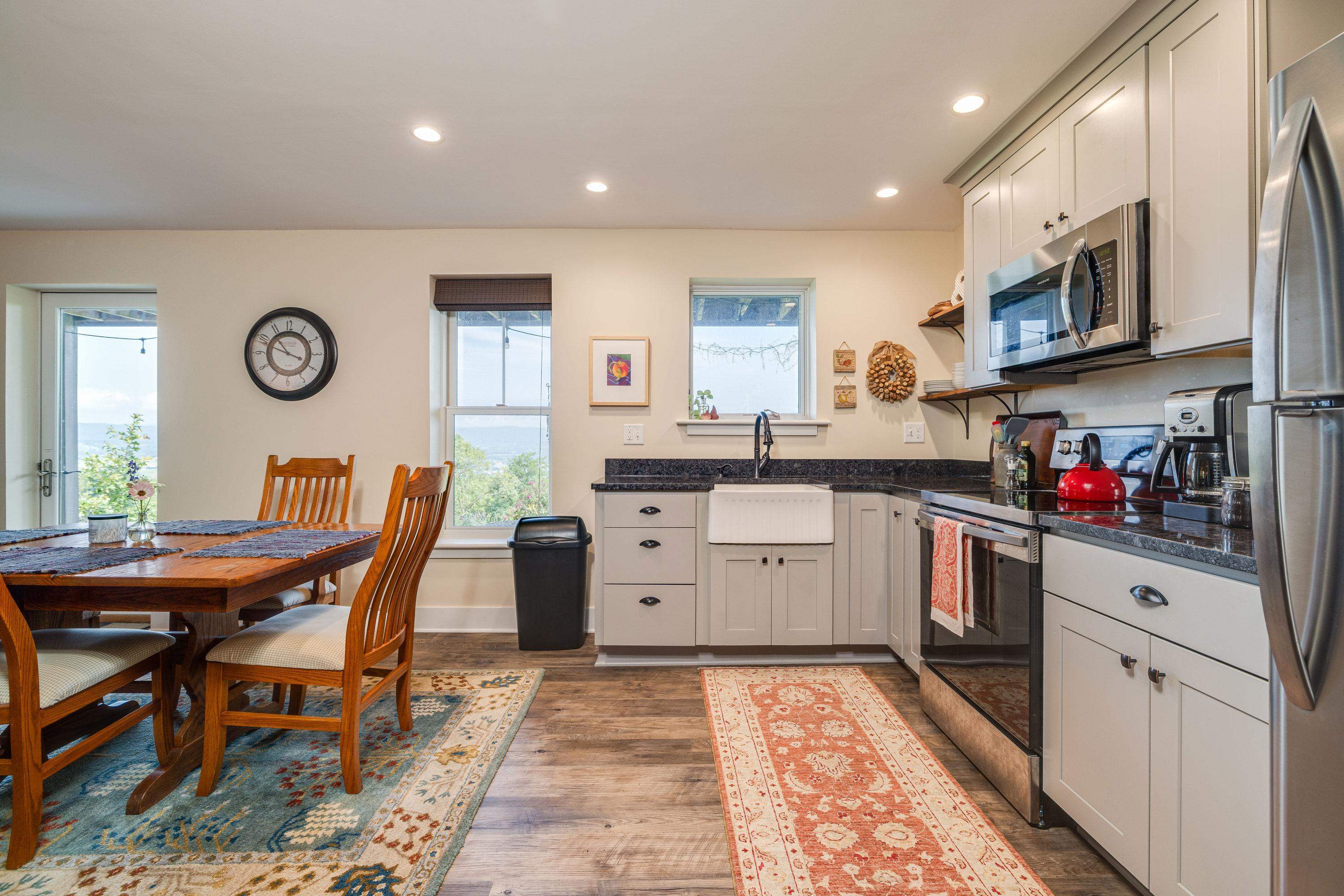 This second kitchen features wooden cabinetry throughout, luxury vinyl plank flooring, stainless steel appliances and much more!