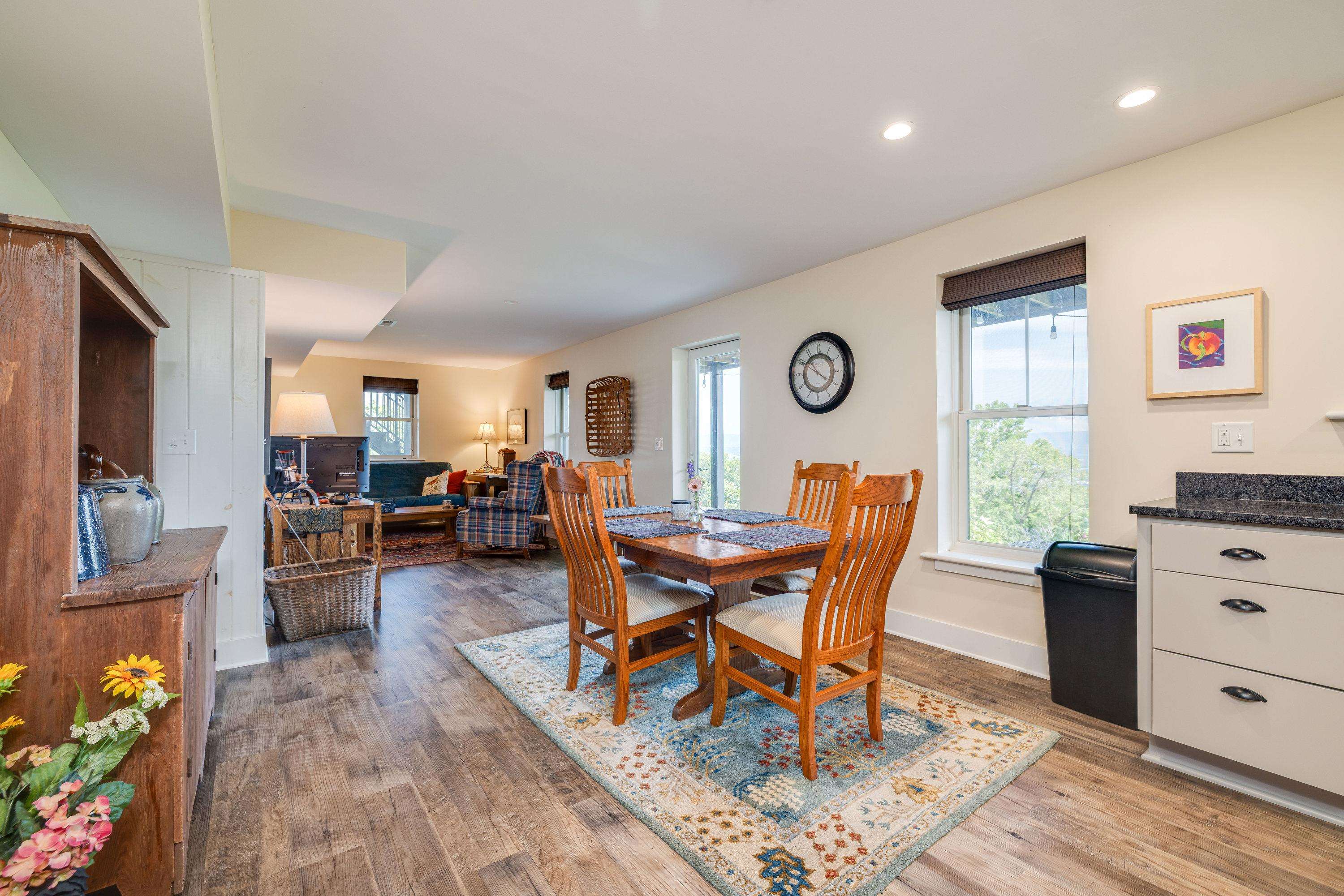 This open concept space features an easy flow from the living room, dining area, and kitchen space.  The bedroom is located off this large area as well!