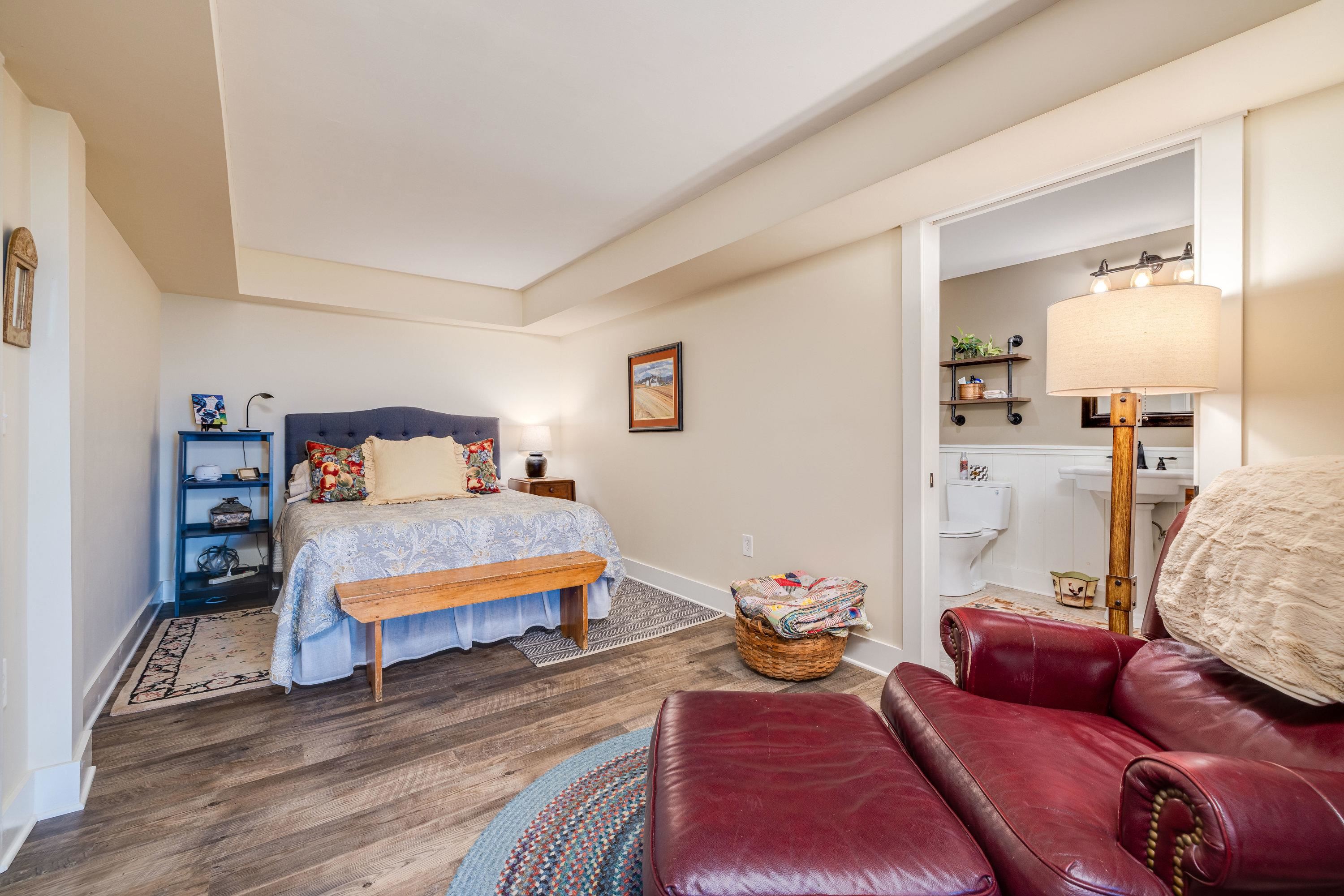 This very large bedroom offers luxury vinyl plank throughout, a spacious closet with storage shelving.  Off this spacious bedroom is a large attached full bathroom.
