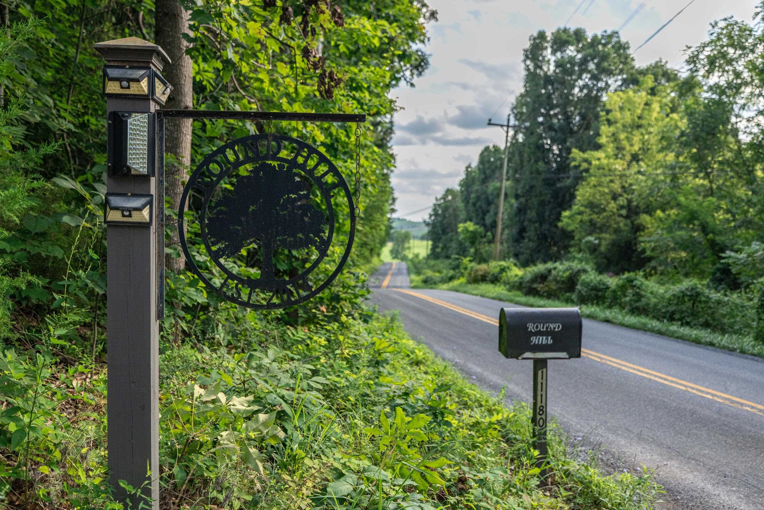 The gravel driveway offers wooded views for a portion of the drive.  This driveway offers lots of privacy.
