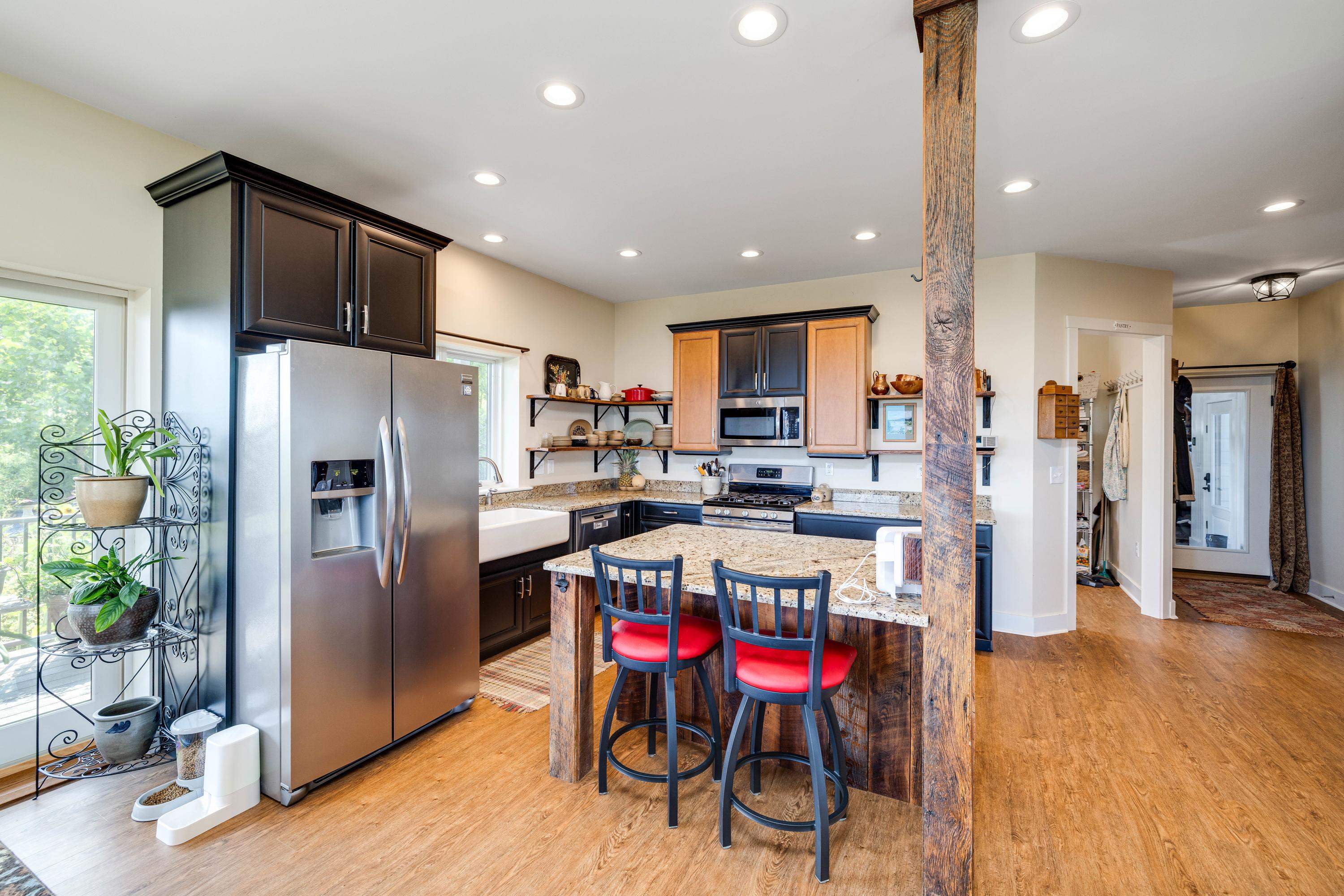 The kitchen features hardwood flooring throughout the space.  Wooden cabinetry, granite counter-tops, recessed lighting, eat-up island area, stainless steel appliances, and much more!