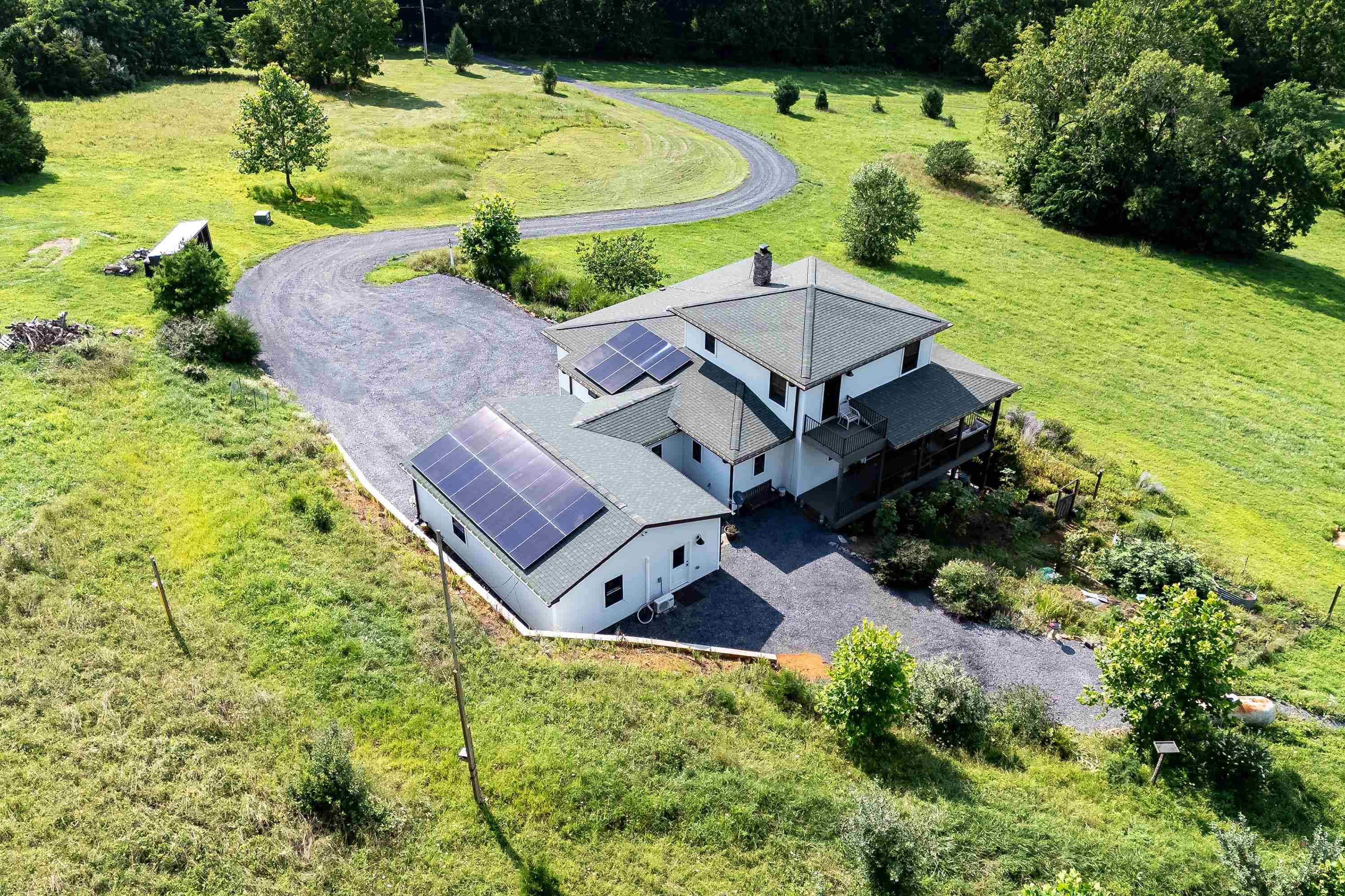 The aerial view shows off the beauty of the views surrounding the home.  From the porch you can view the mountains, valley, and overlook the spacious lot surrounding the home.