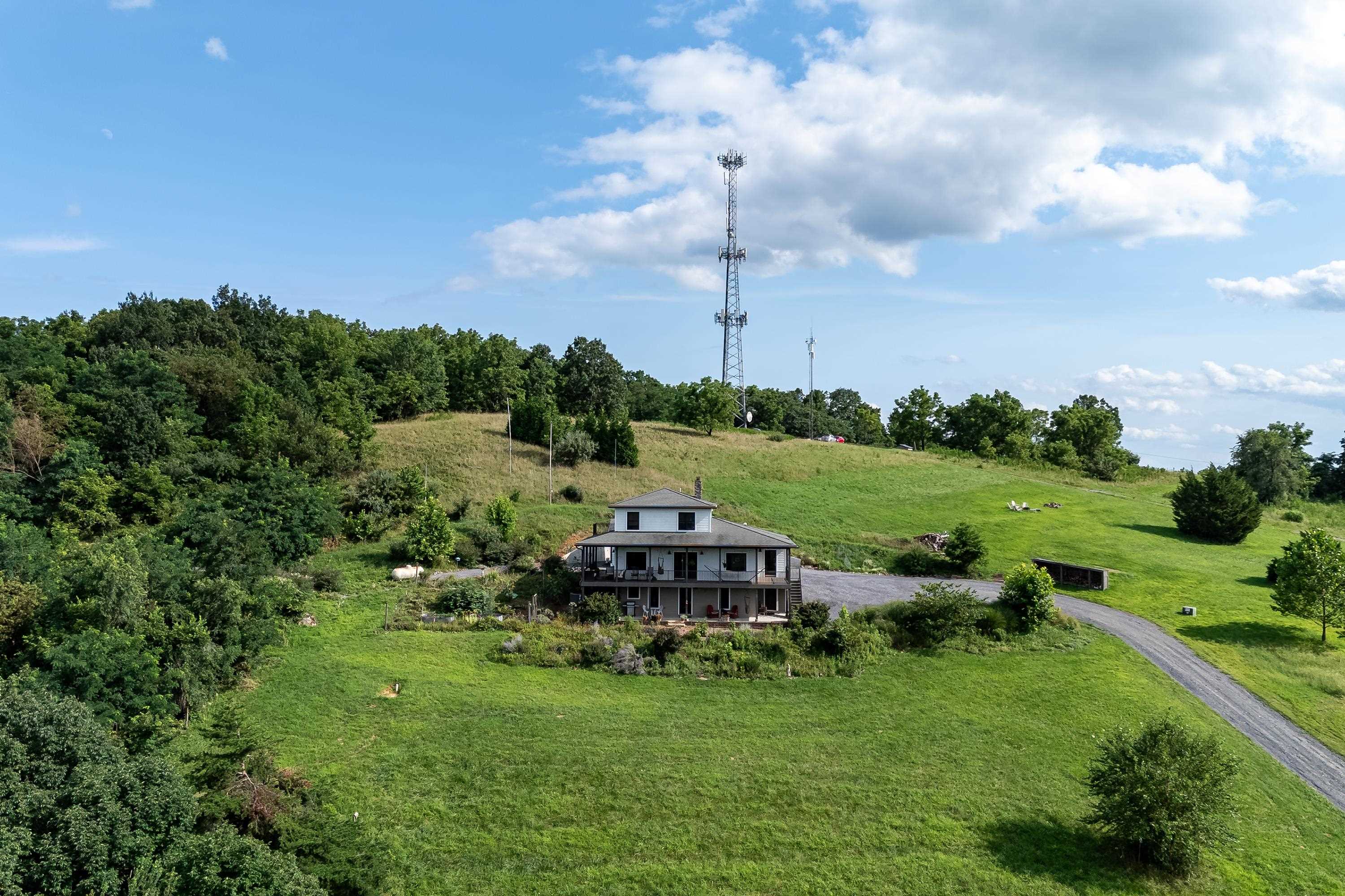 The aerial view shows off the beauty of the views surrounding the home.  From the porch you can view the mountains, valley, and overlook the spacious lot surrounding the home.