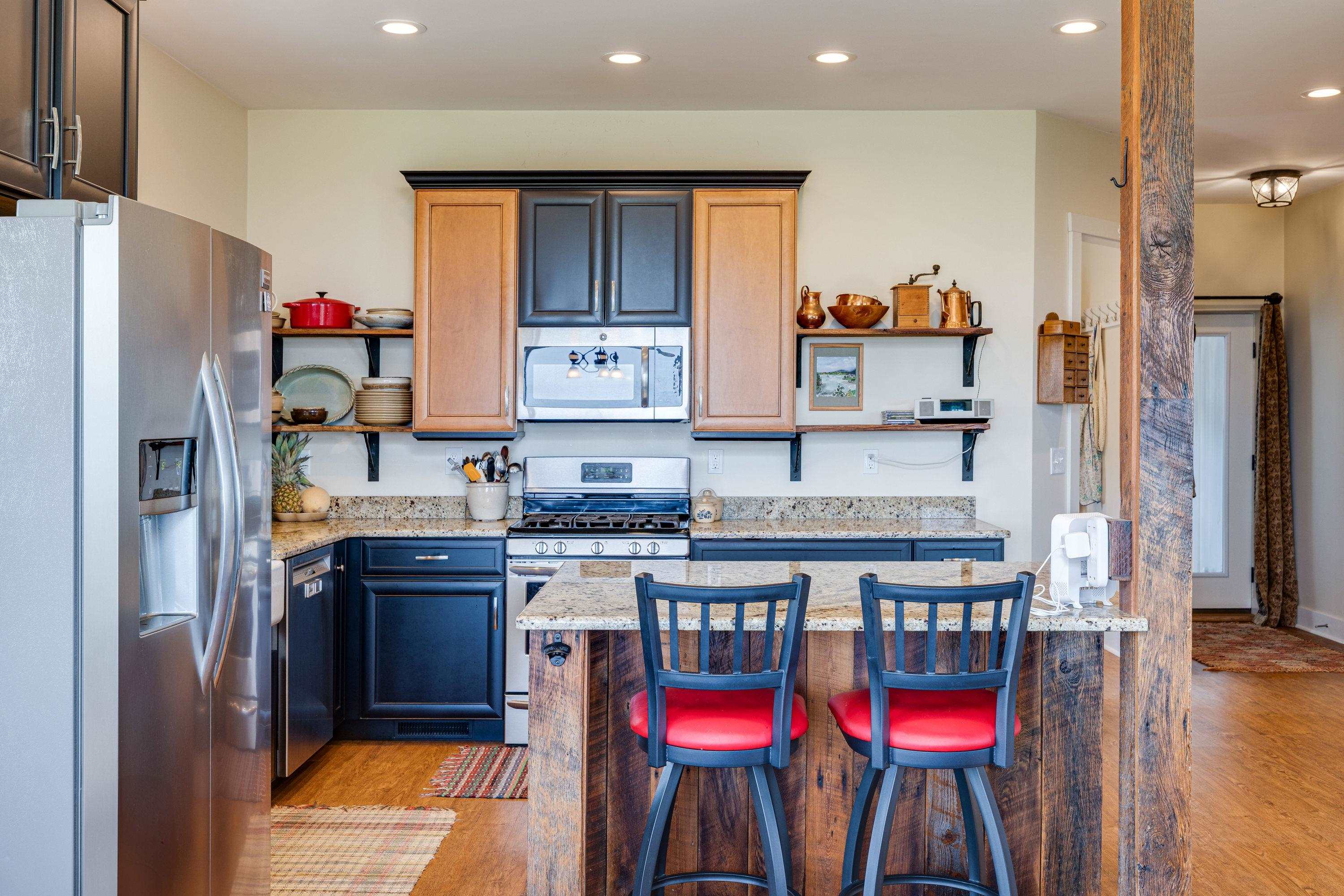 The kitchen features hardwood flooring throughout the space.  Wooden cabinetry, granite counter-tops, recessed lighting, eat-up island area, stainless steel appliances, and much more!