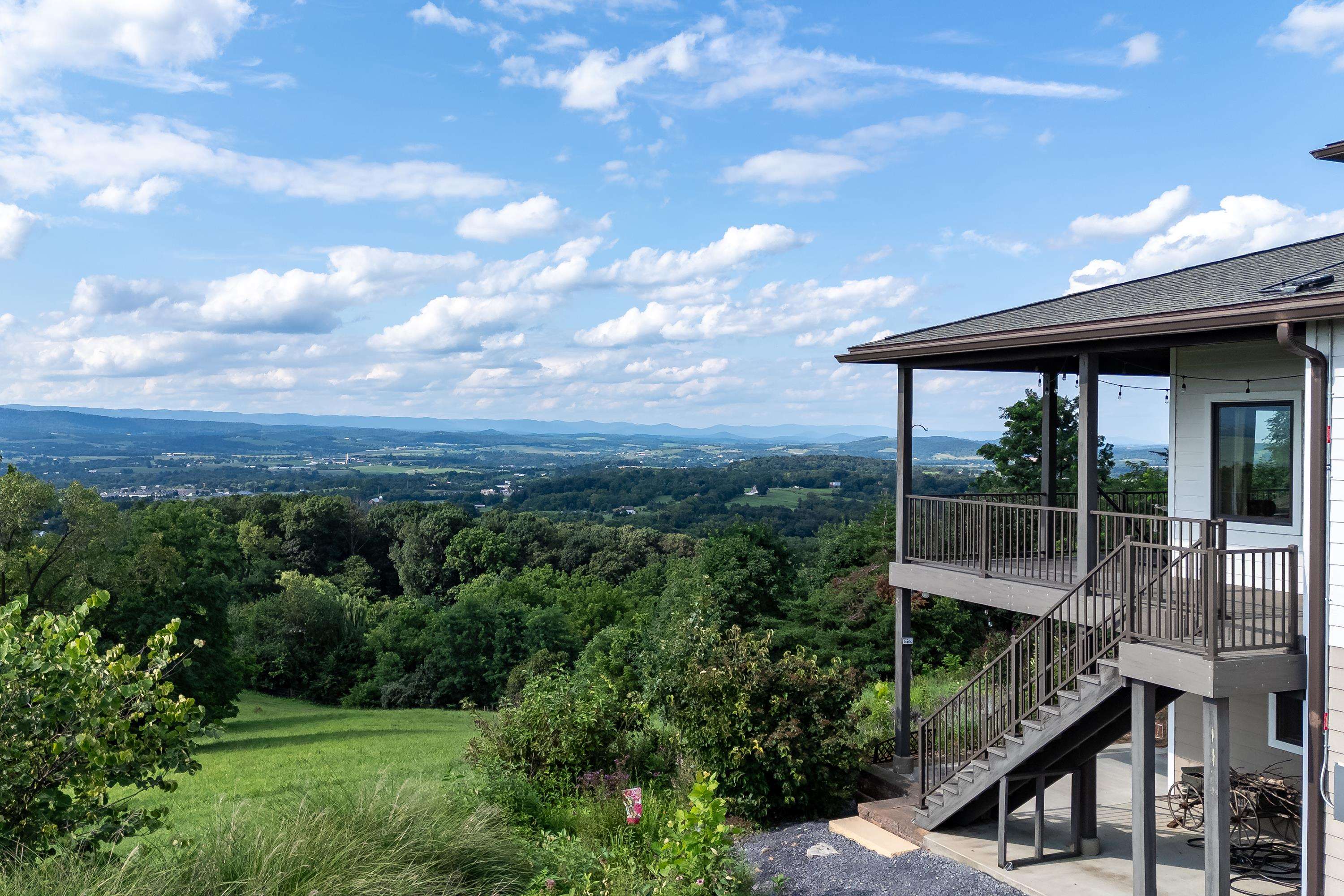 The aerial view shows off the beauty of the views surrounding the home.  From the porch you can view the mountains, valley, and overlook the spacious lot surrounding the home.