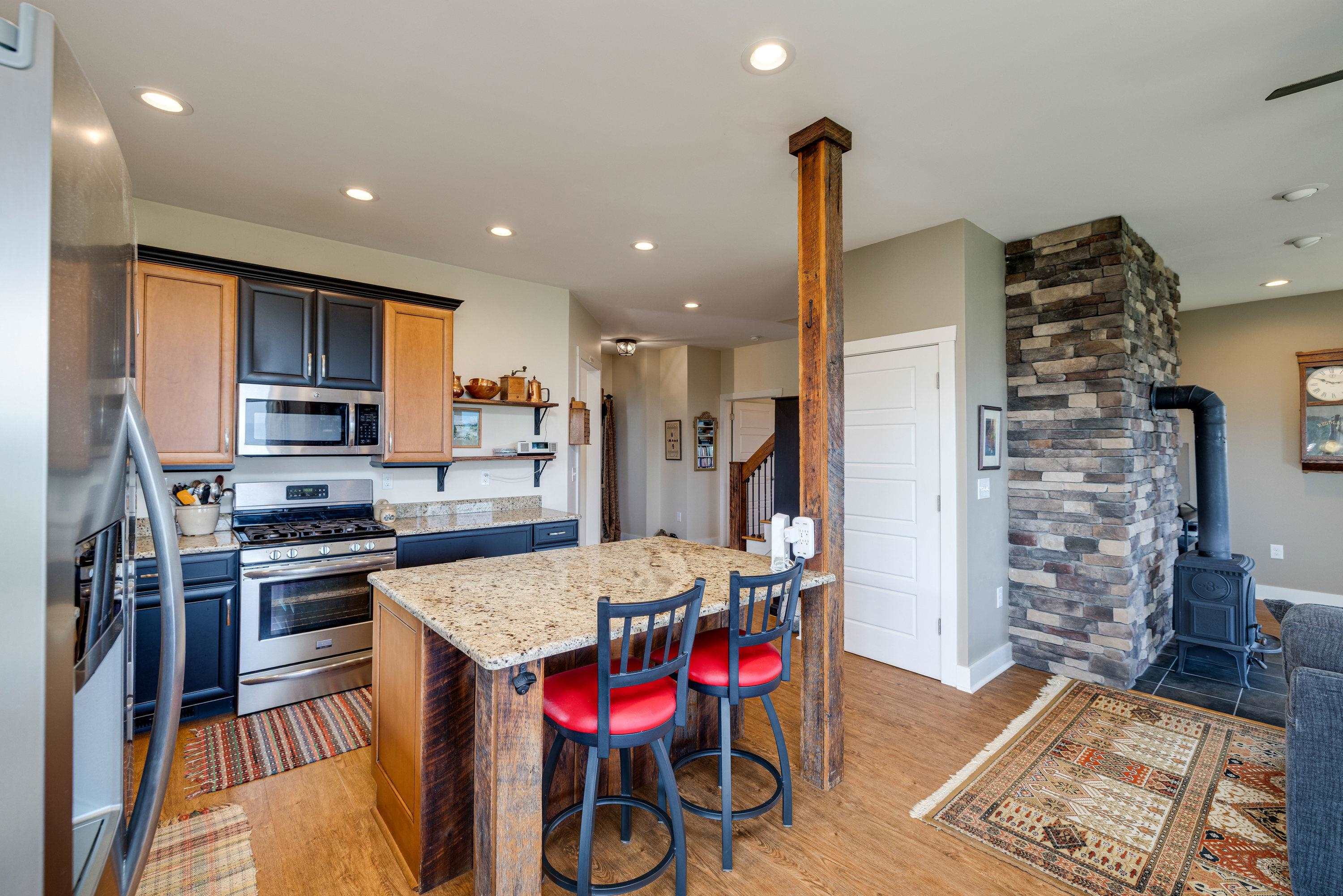 The kitchen features hardwood flooring throughout the space.  Wooden cabinetry, granite counter-tops, recessed lighting, eat-up island area, stainless steel appliances, and much more!