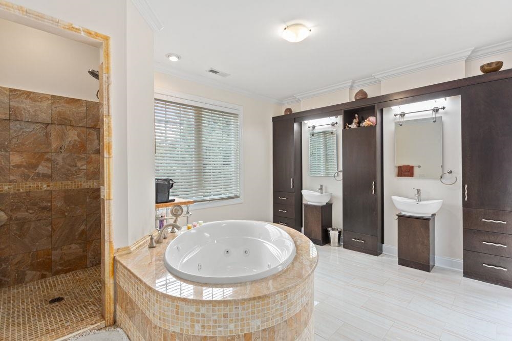 duel sinks, jet tub, tile walk in shower