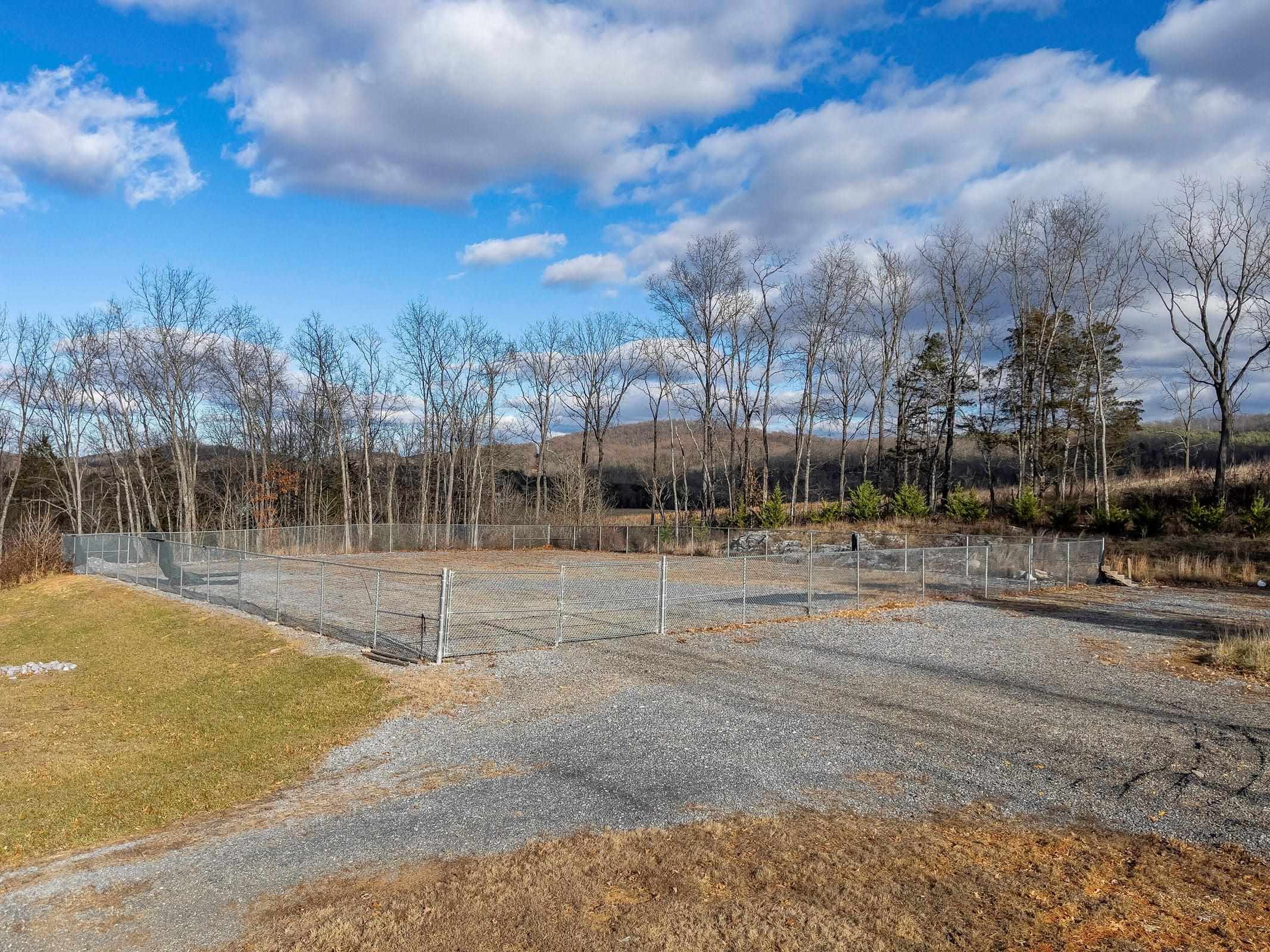 The majority of the lot has been cleared with a portion leveled and a gravel pad in place.