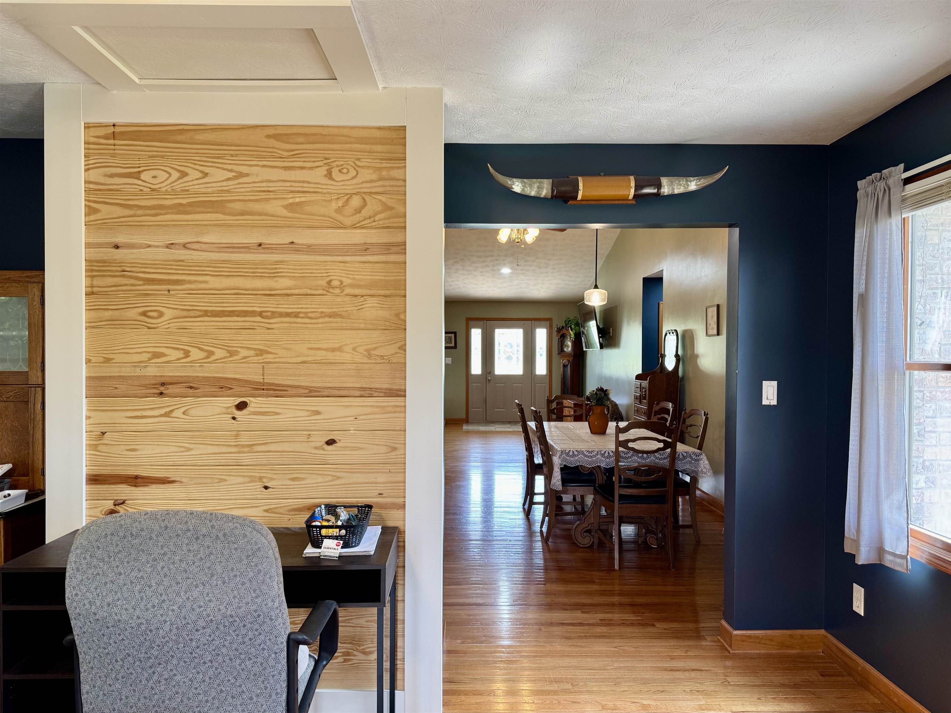 Fireplace flue behind tongue and groove wall in Den
