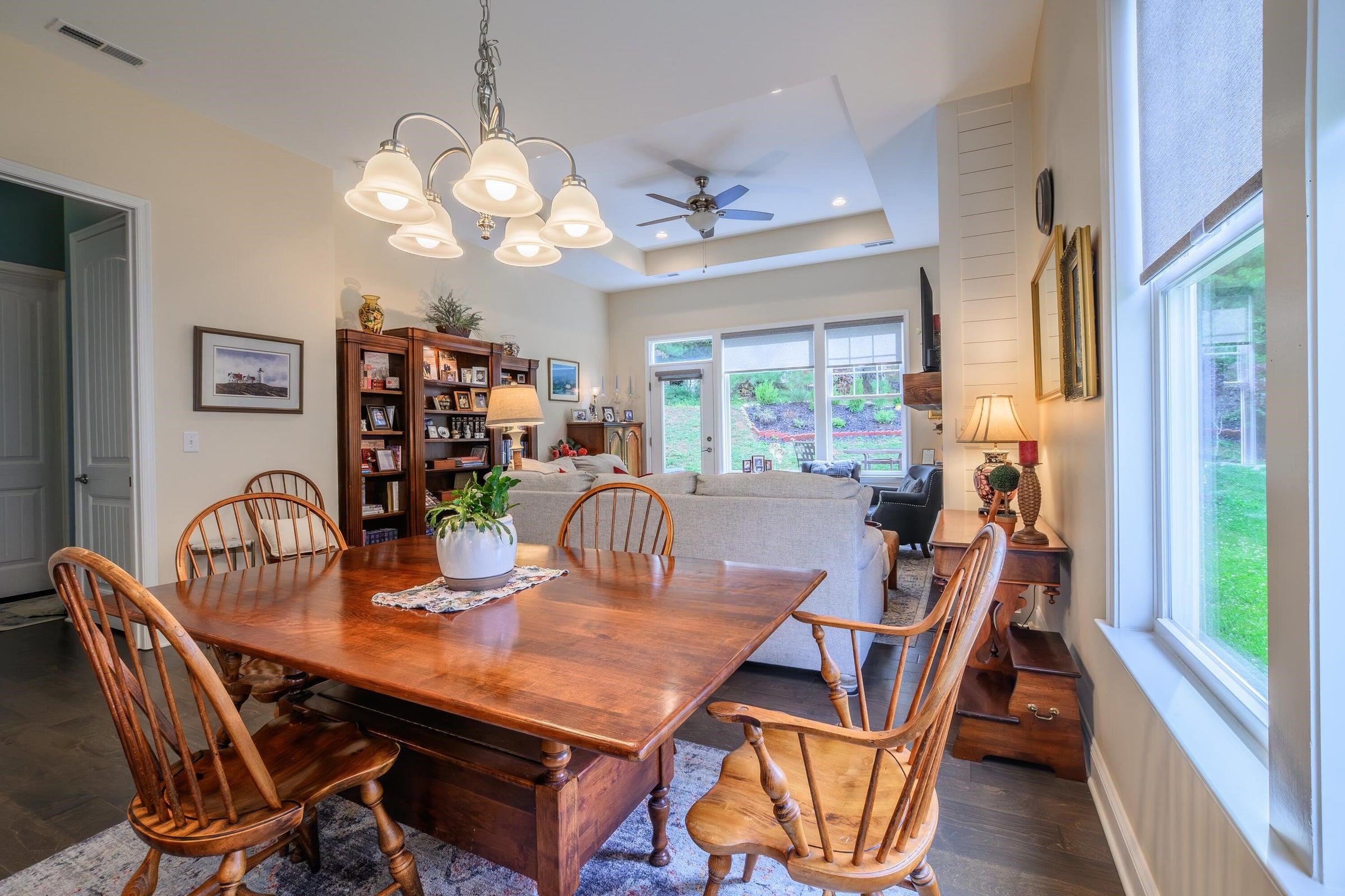 Dining area with light-filled windows.