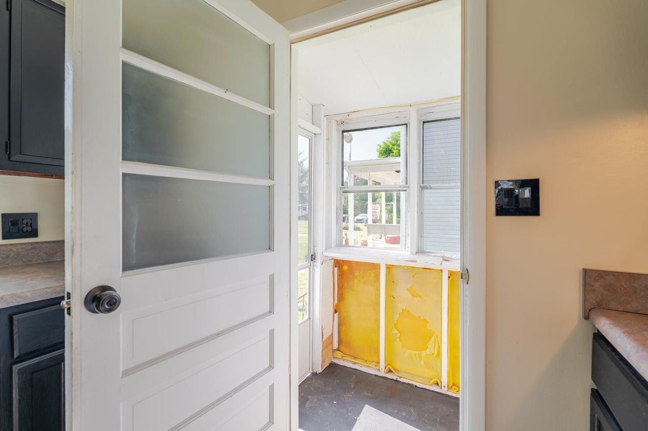 This nice enclosed porch off the kitchen offers lots of potential....place to start seeds, sun loving plants, keep critters out of the trash.... What's your idea?