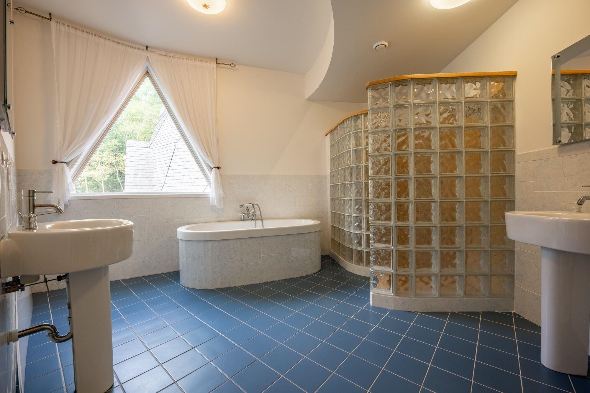 Master Bath with tile floor, walk-in shower, soaking tub, two separate sinks.