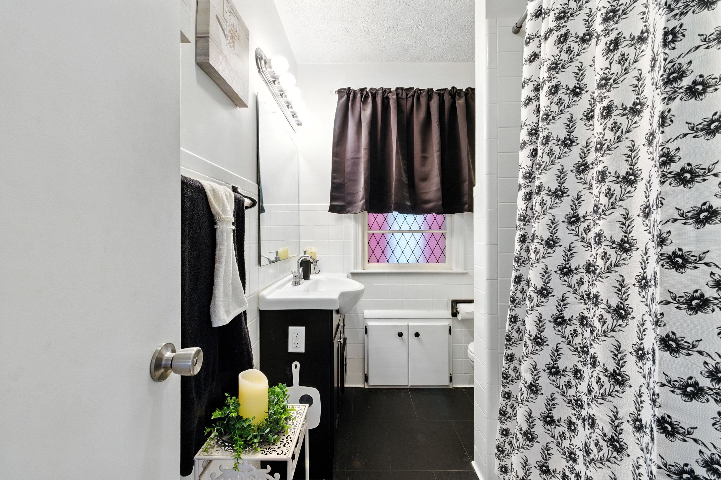 Bathroom has shower/tub combo.