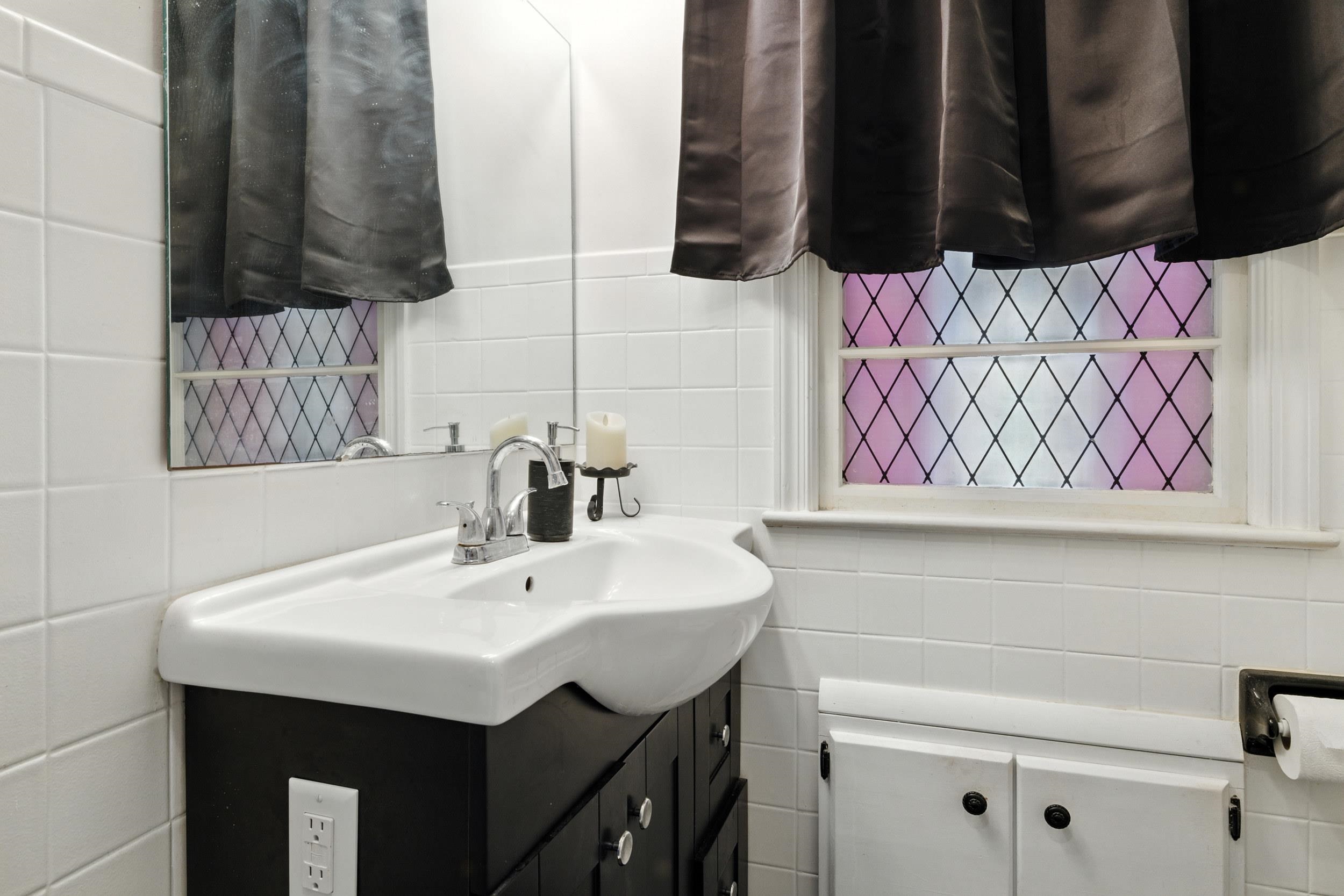 Bathroom sports a sleek vanity.