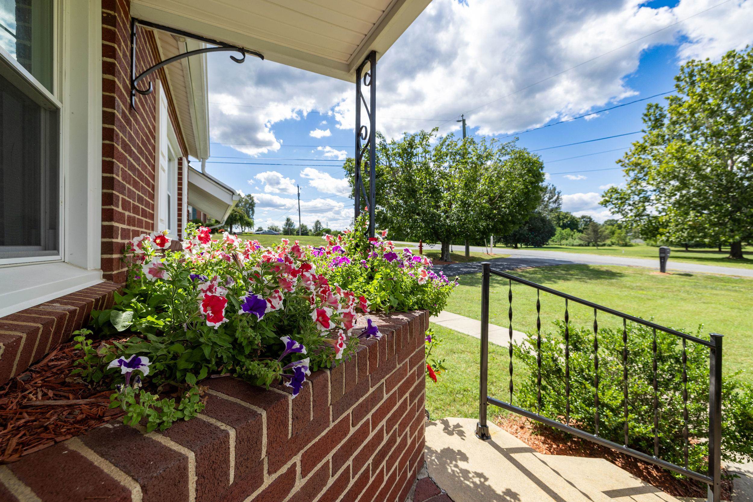 Flower box on front porch adds a lot of color!