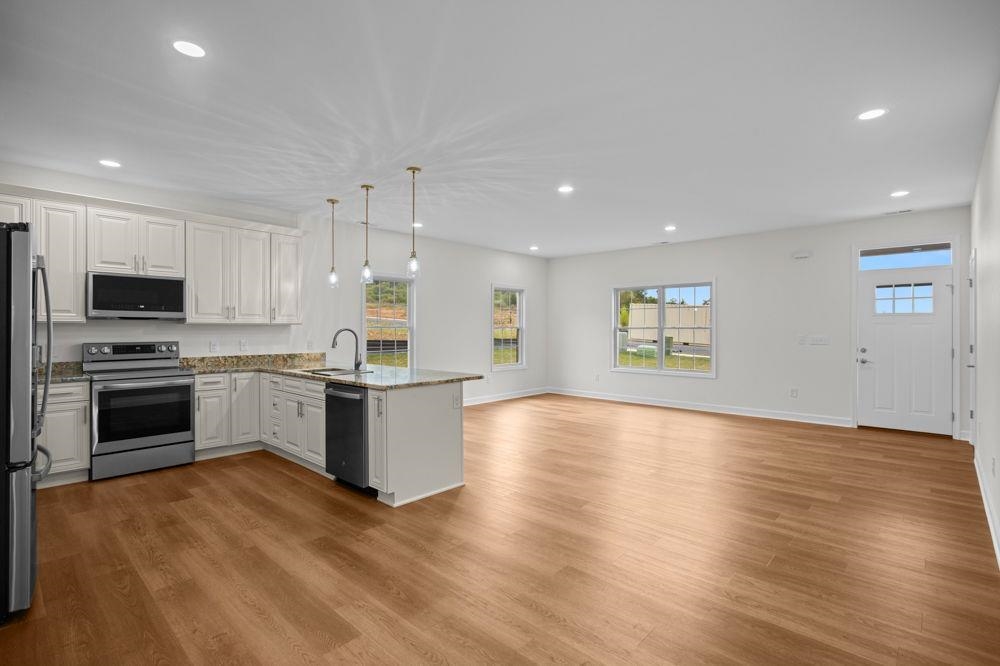of living room, kitchen and dining area.  Lots of windows for abundant natural light.
