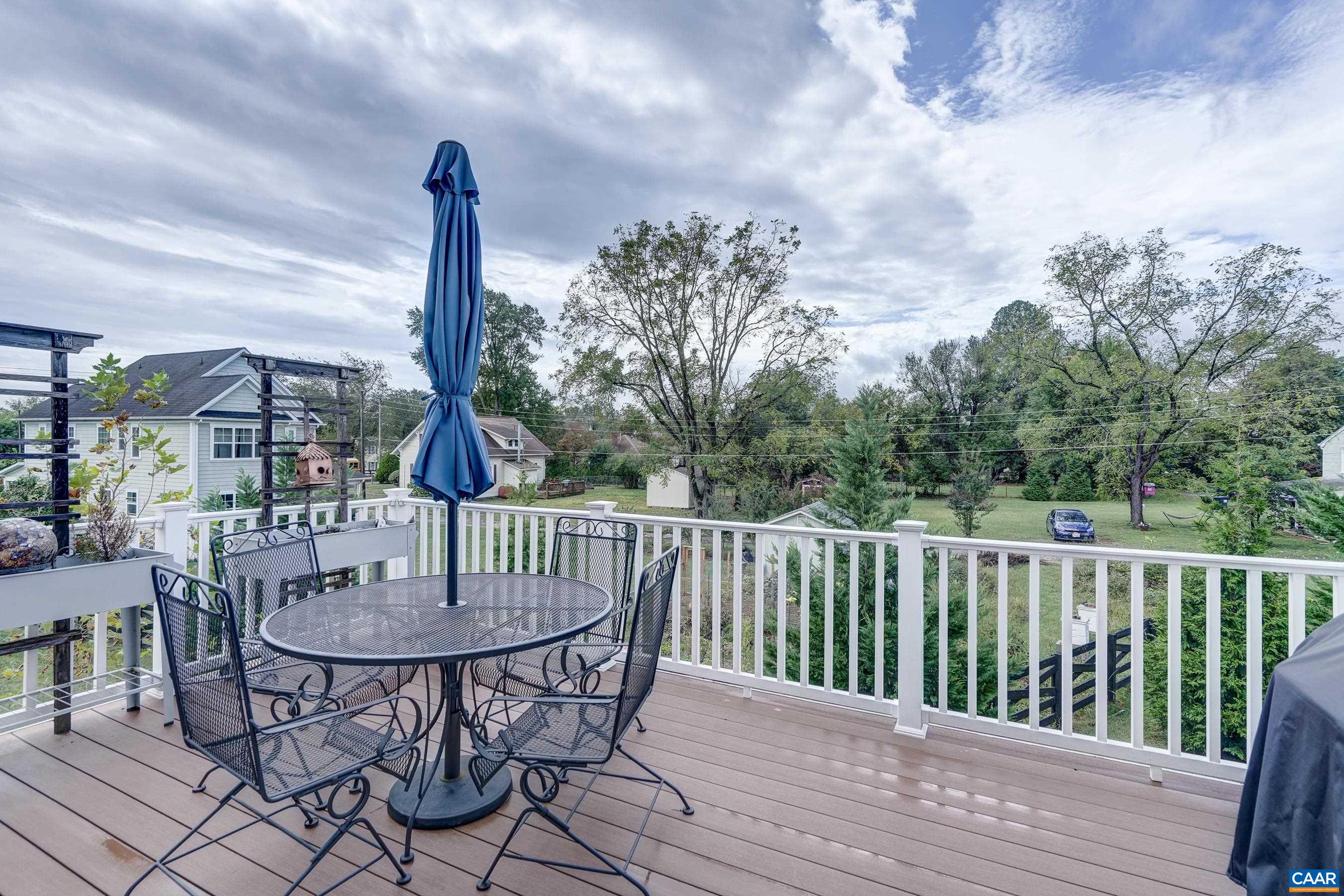 Rear deck overlooks common green space.