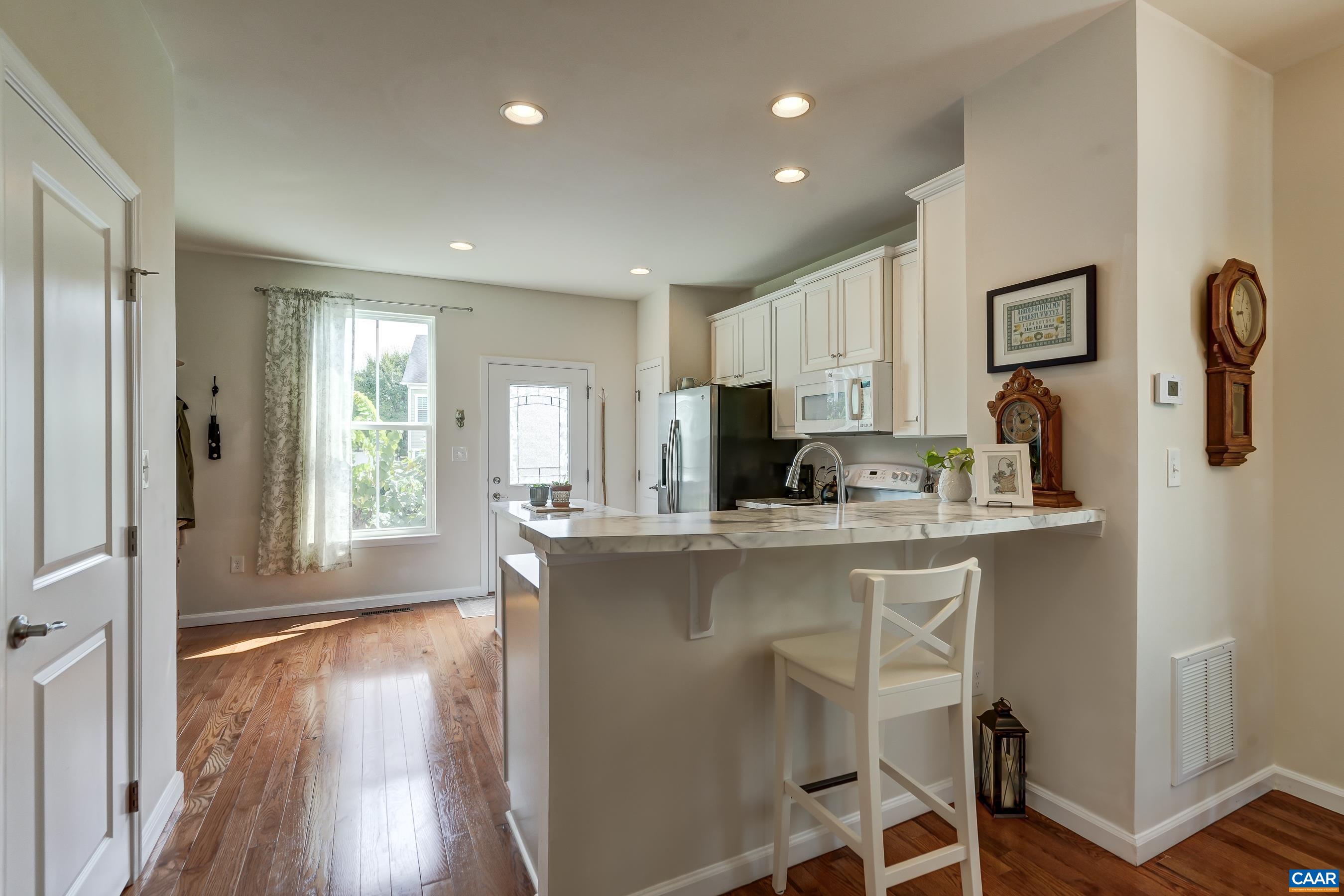 Open kitchen with breakfast bar.