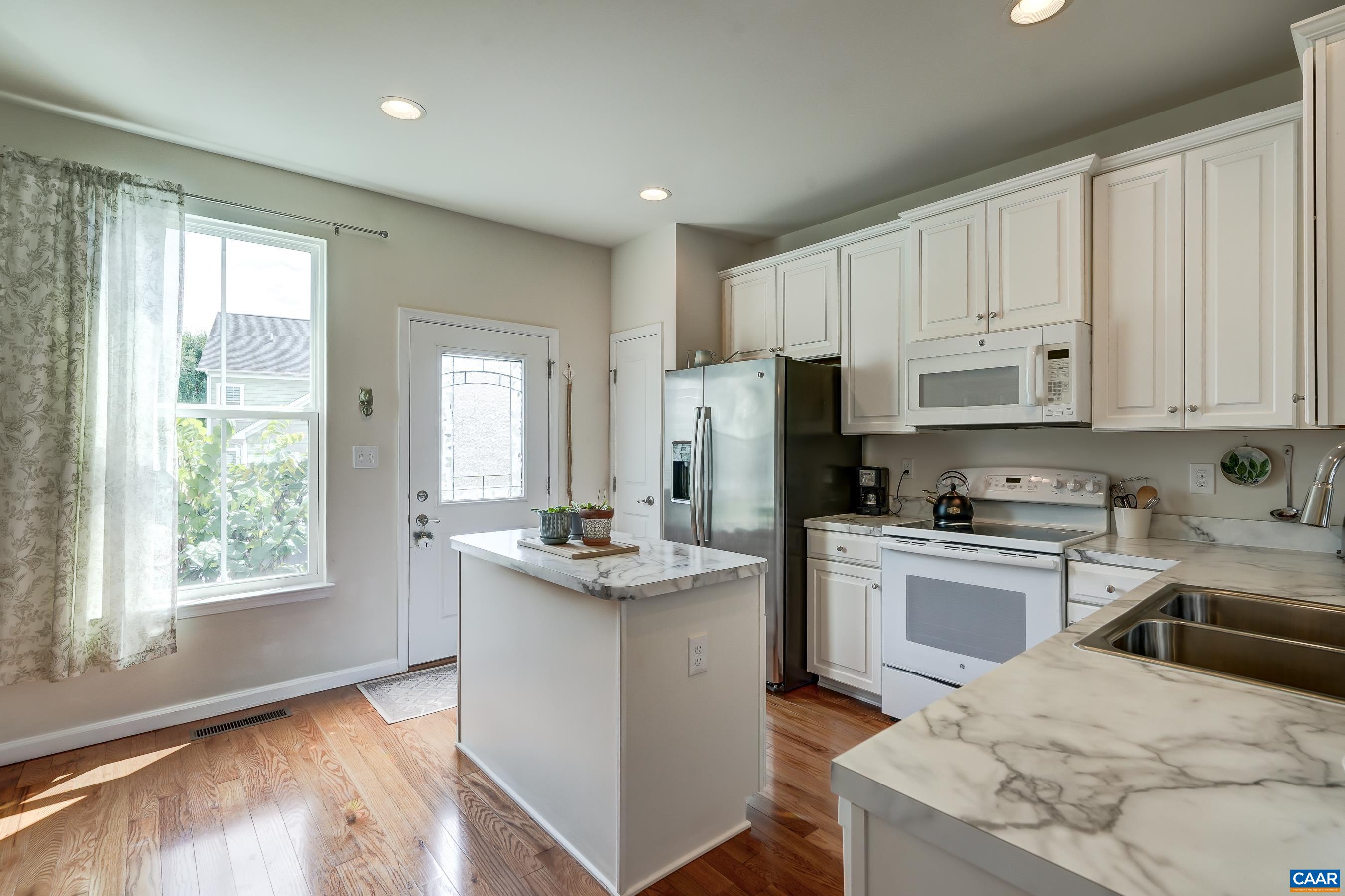 Island worksurface in white kitchen.