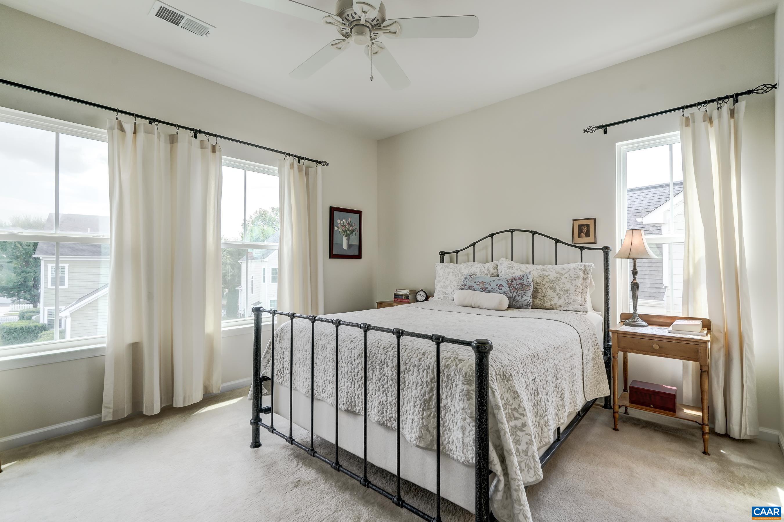 Primary bedroom features ceiling fan and large closet.