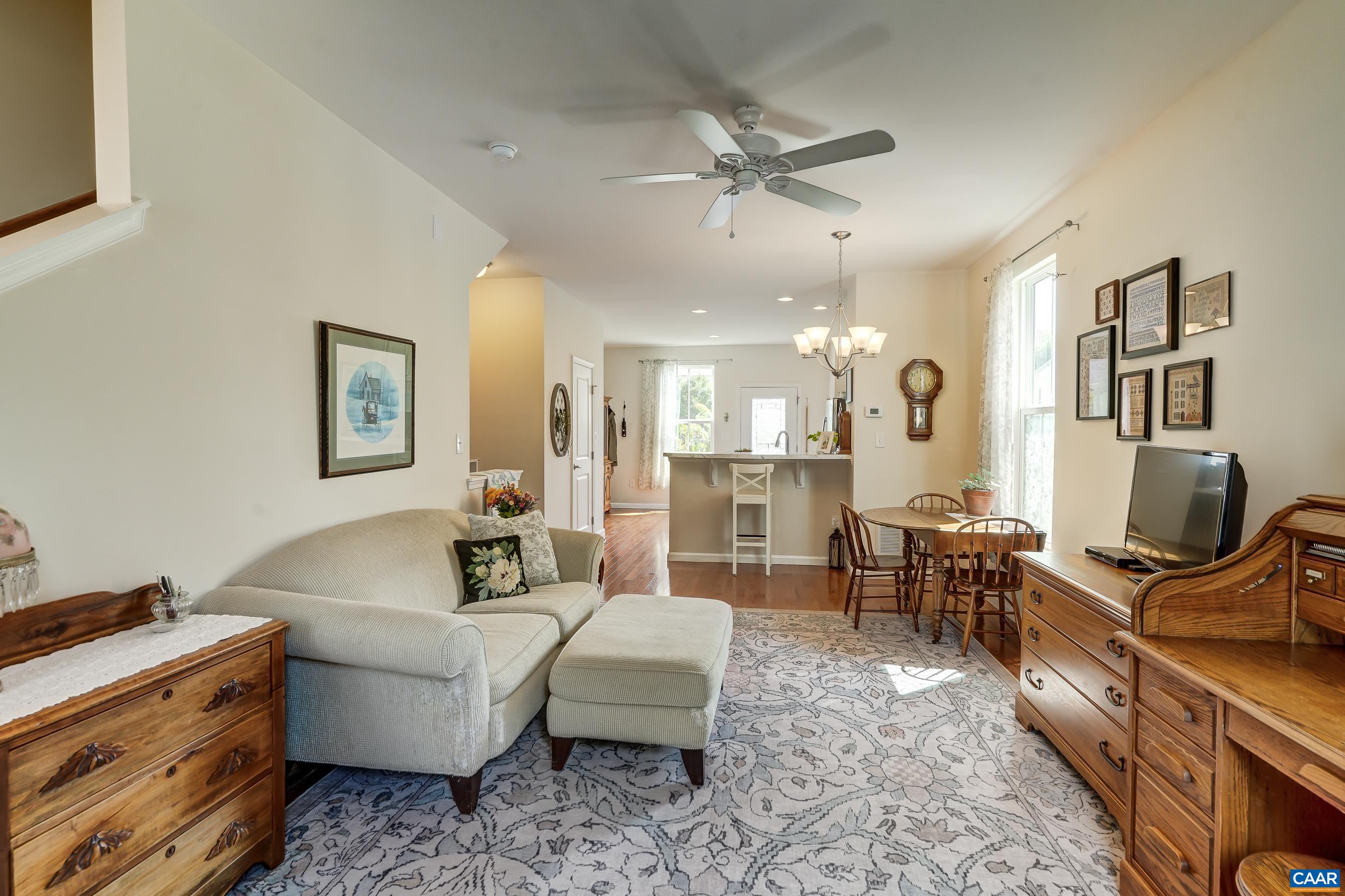 Light and airy living room with high ceilings and fan.