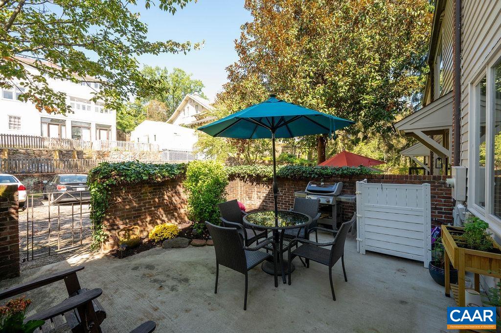 Cozy walled terrace with garden area exits to the private parking area.
