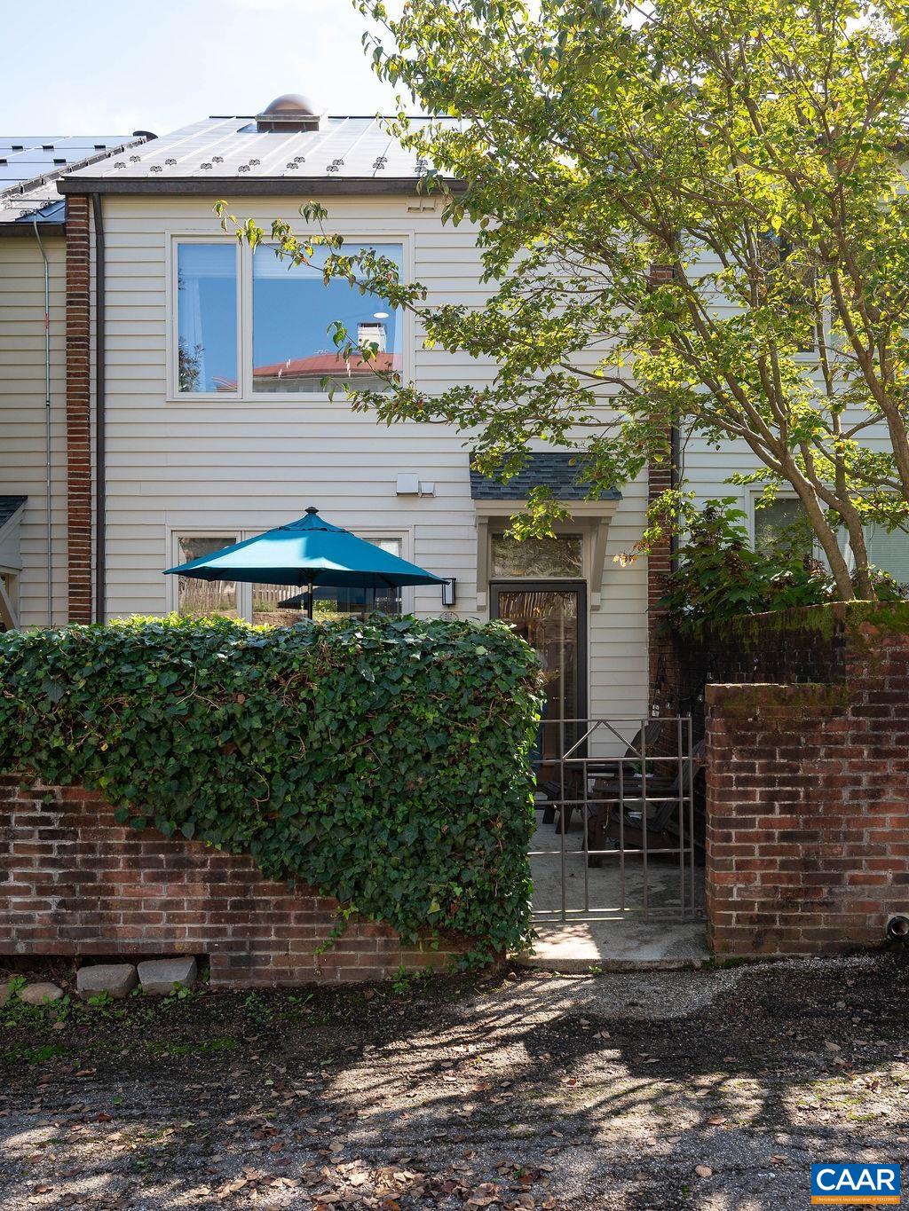 Entrance to walled patio and home's rear entry