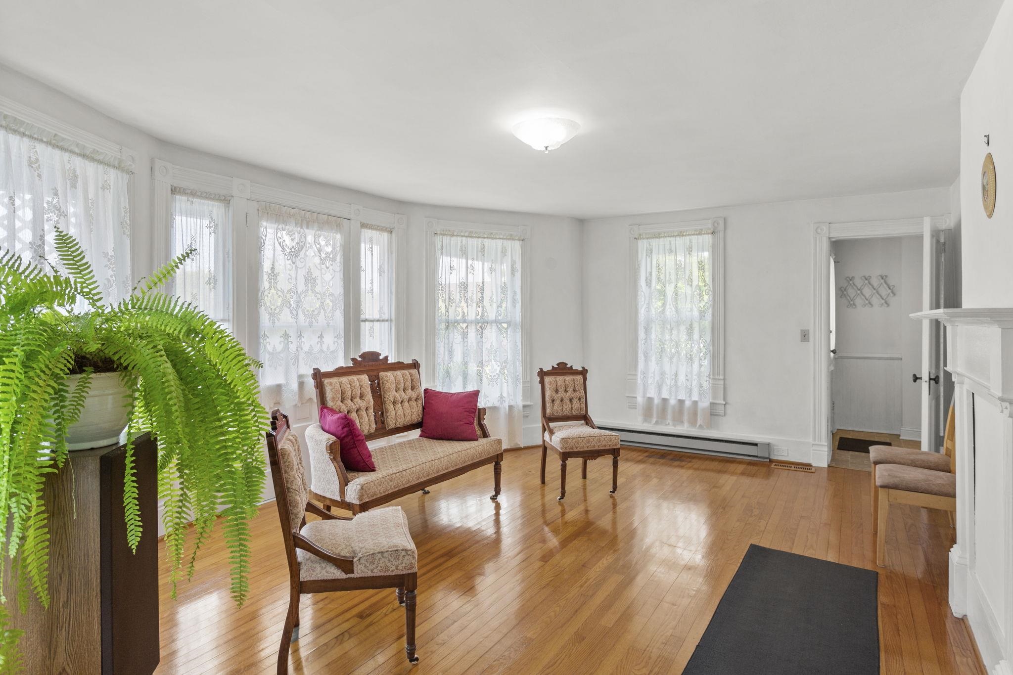 with old fireplace and bowed windows.